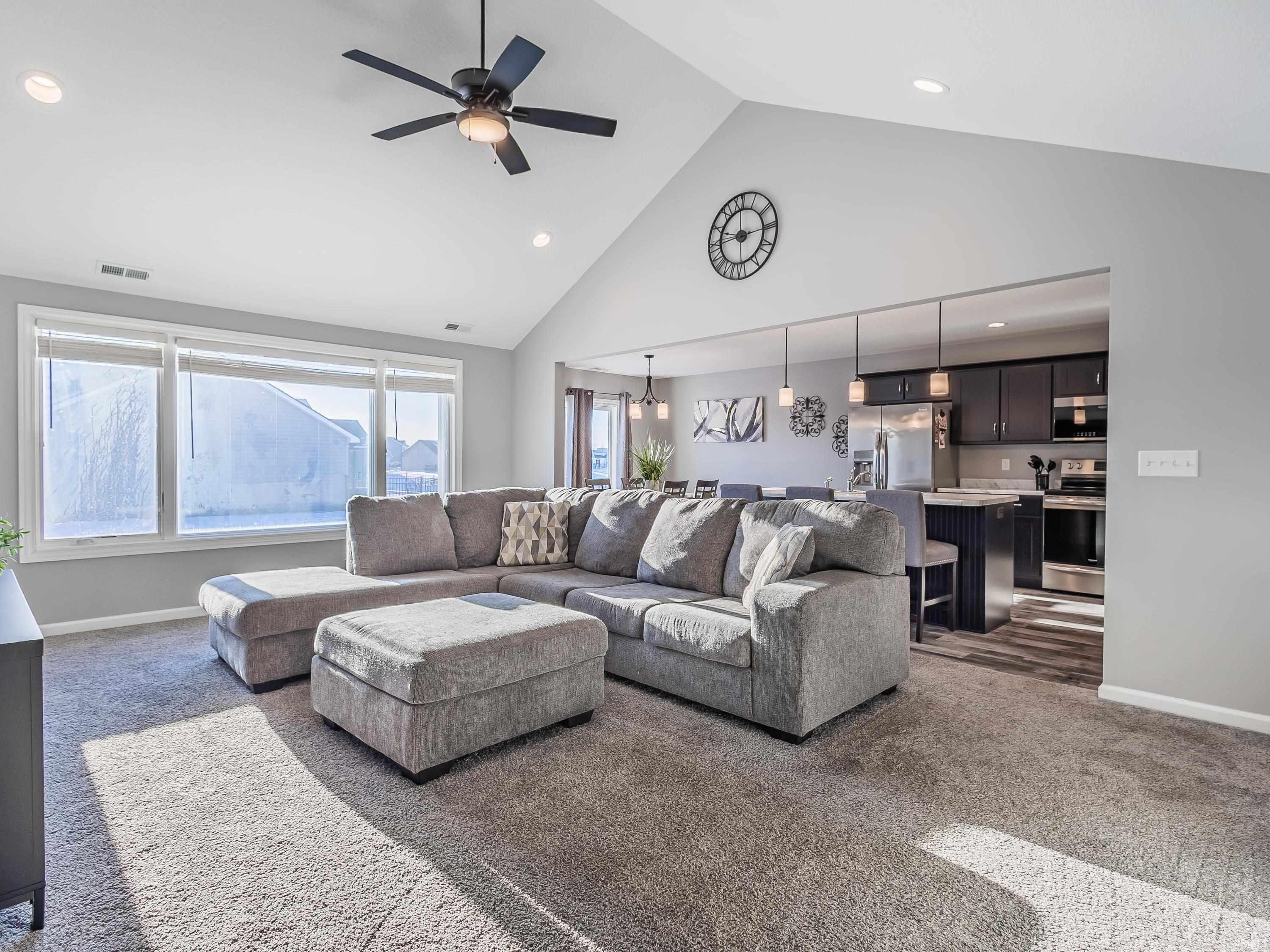 Living room with, recessed lighting, high vaulted ceiling, and picture windows