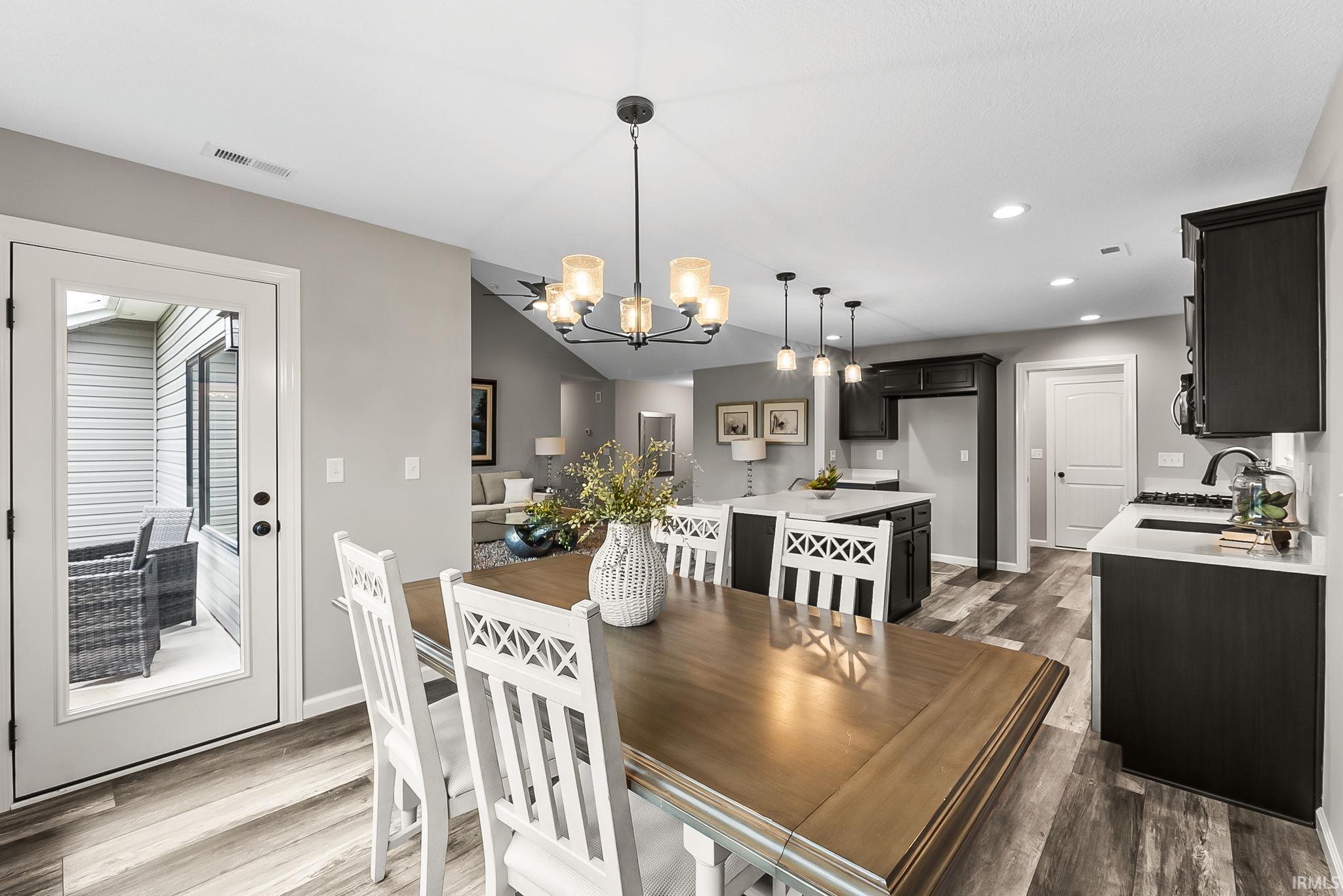 Dining area featuring light wood finished floors and suspended lighting