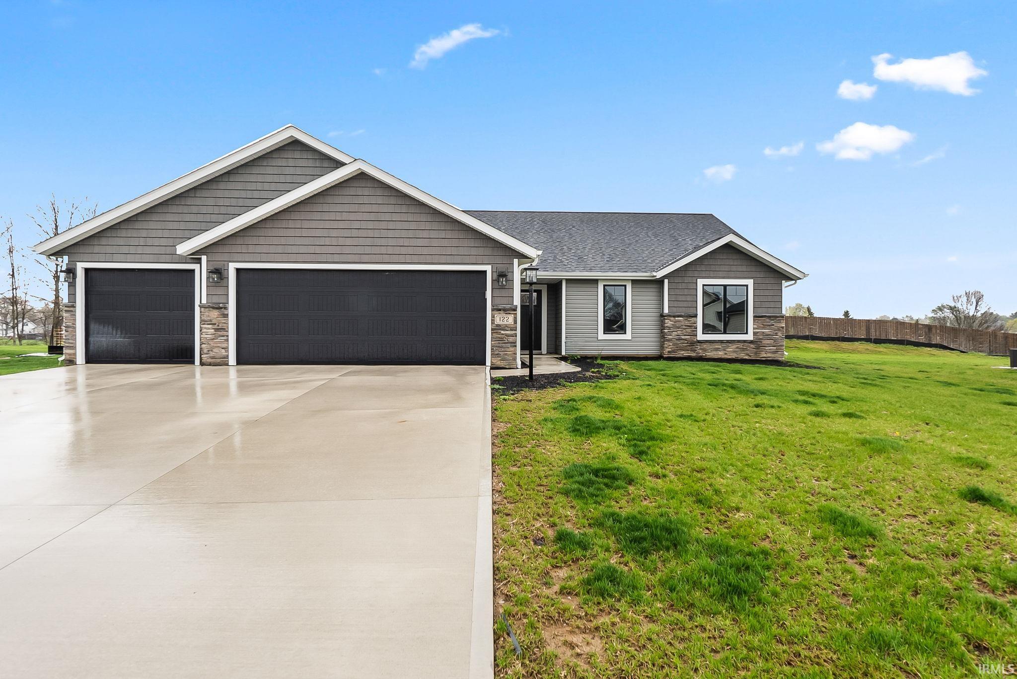 Craftsman-style house with stone siding, an attached garage, concrete driveway, and roof with shingles