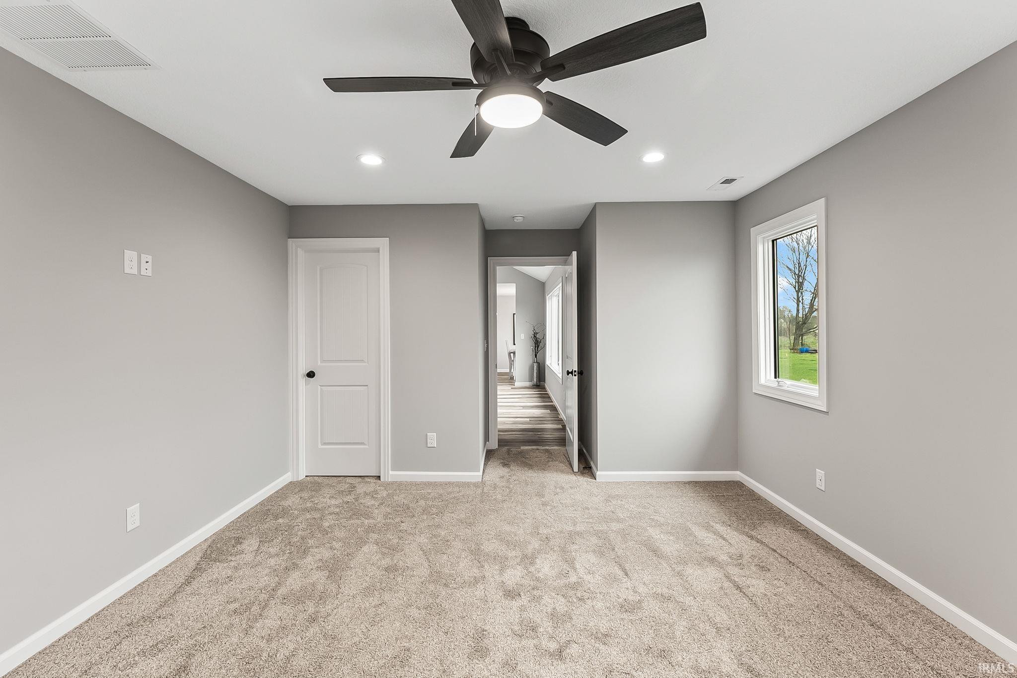 Unfurnished bedroom with recessed lighting, ceiling fan, and light carpet