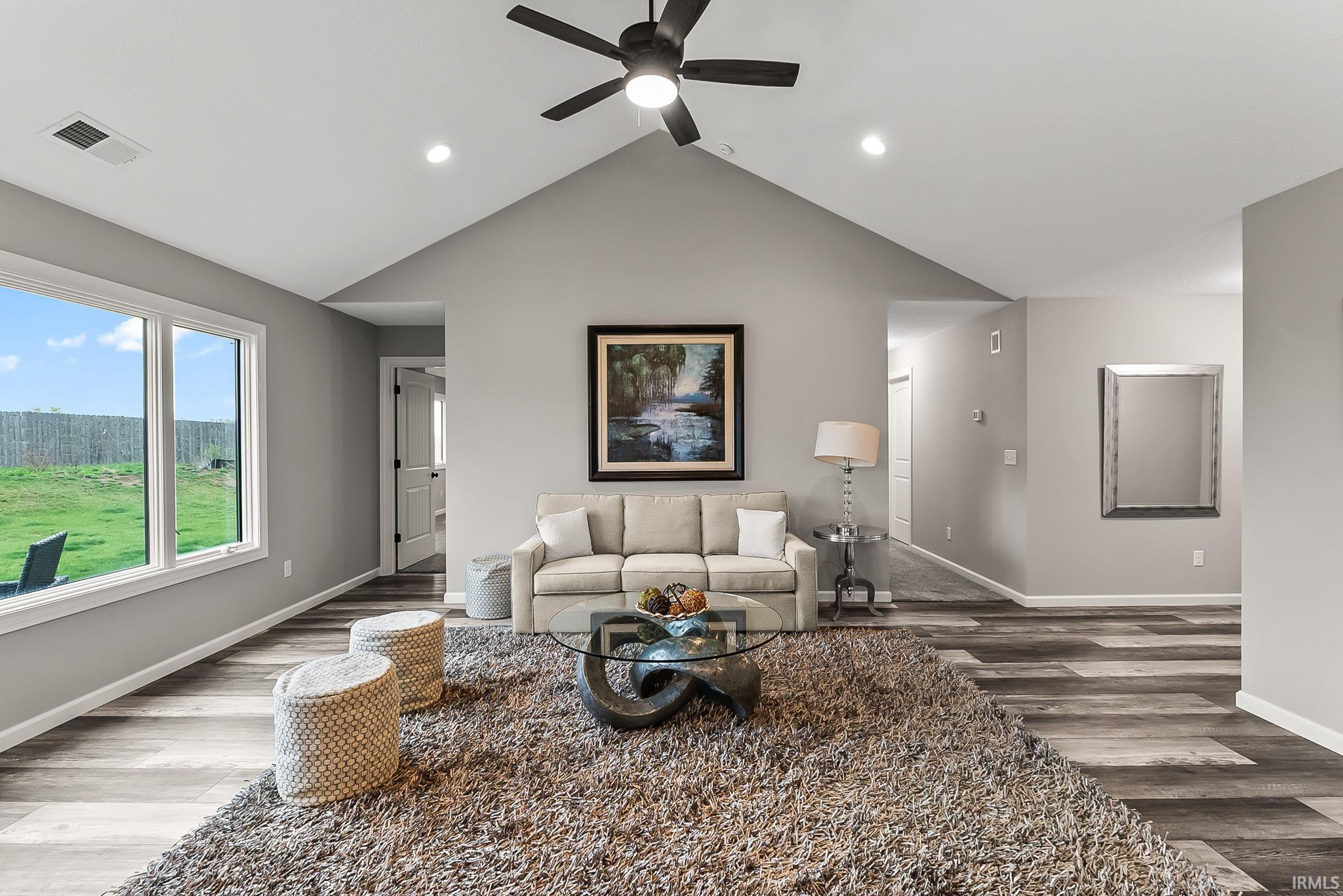 Living room with dark wood-style floors, a ceiling fan, and recessed lighting