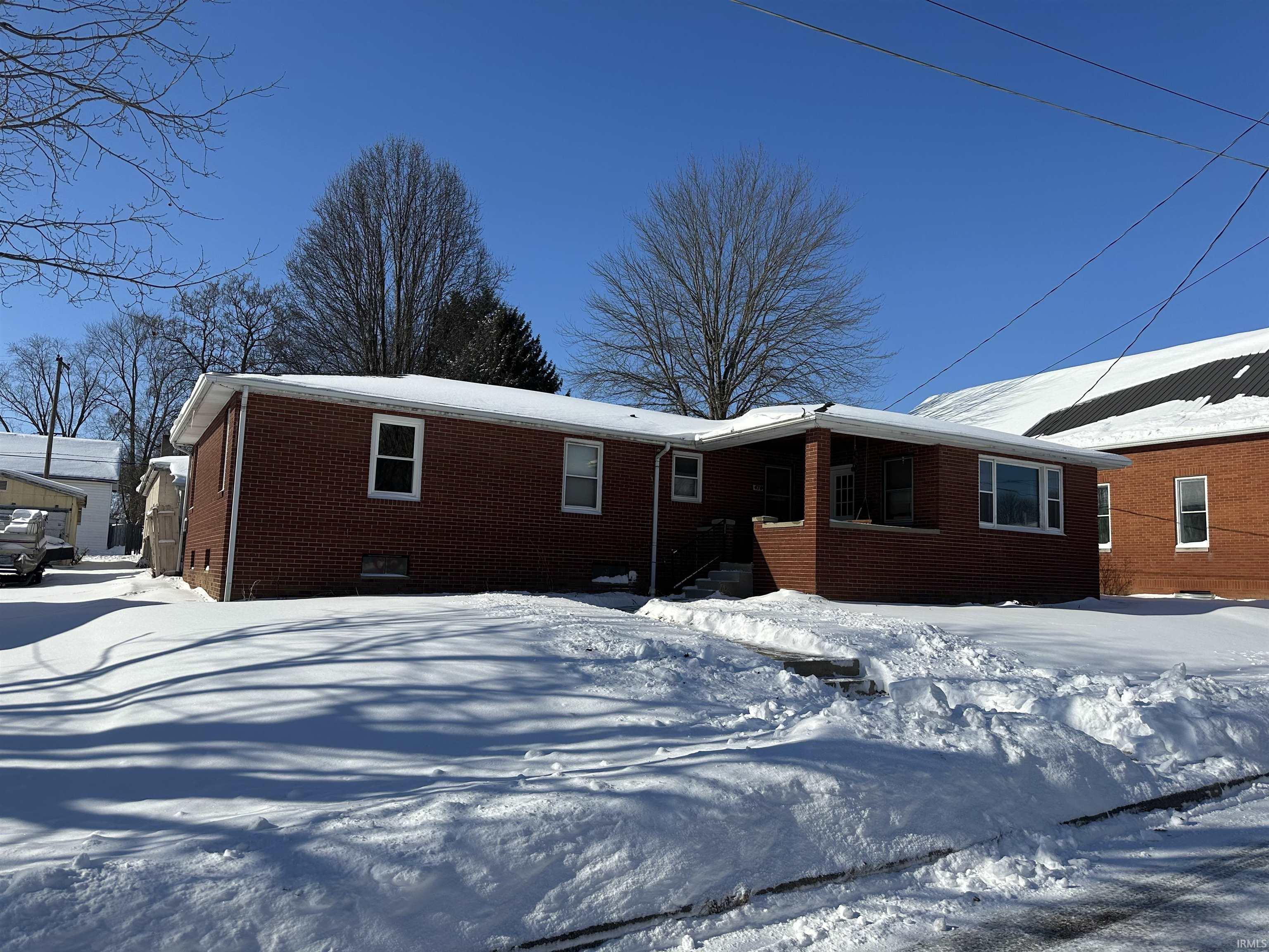 View of front facade featuring brick siding