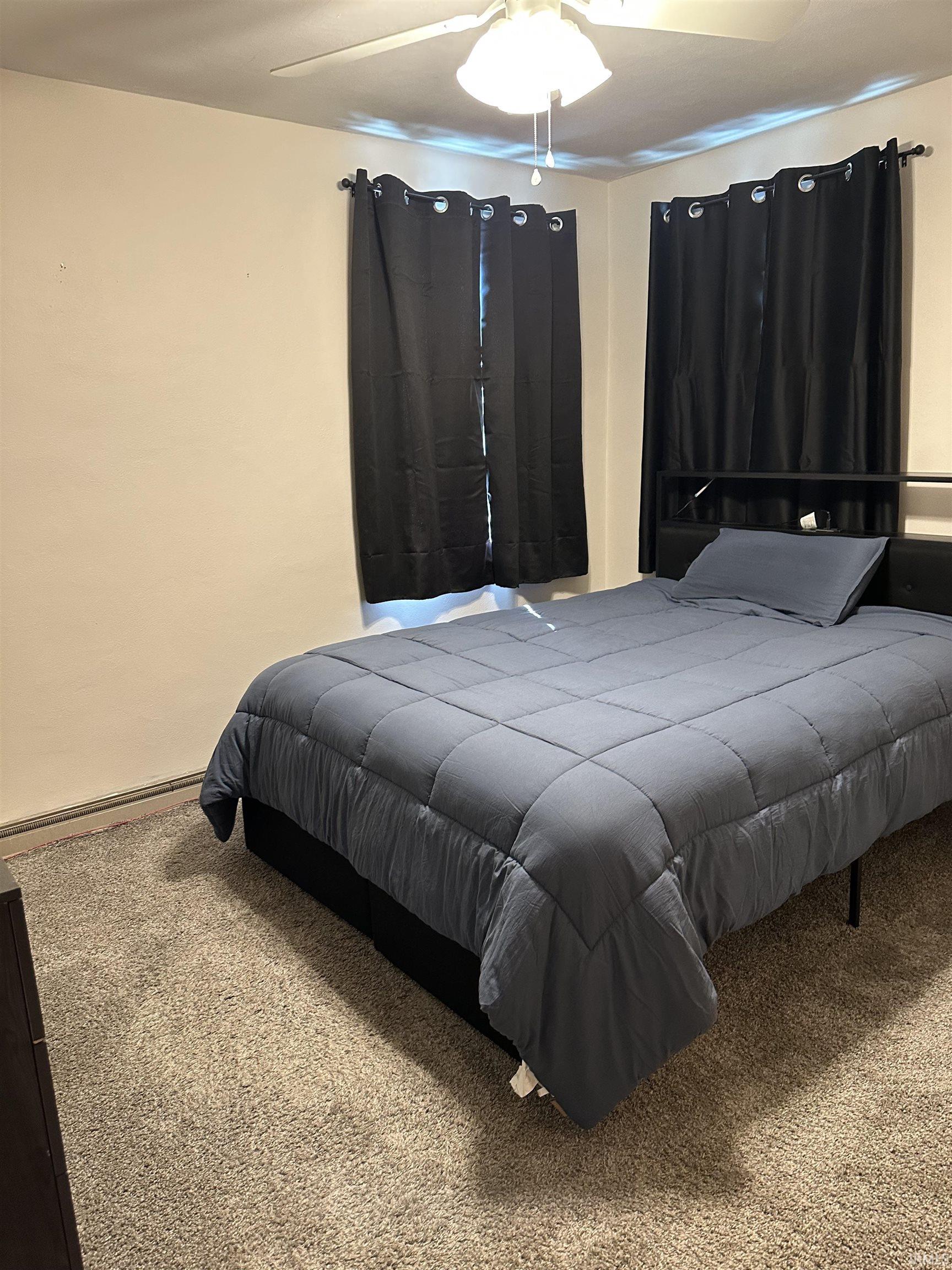Bedroom featuring carpet and ceiling fan
