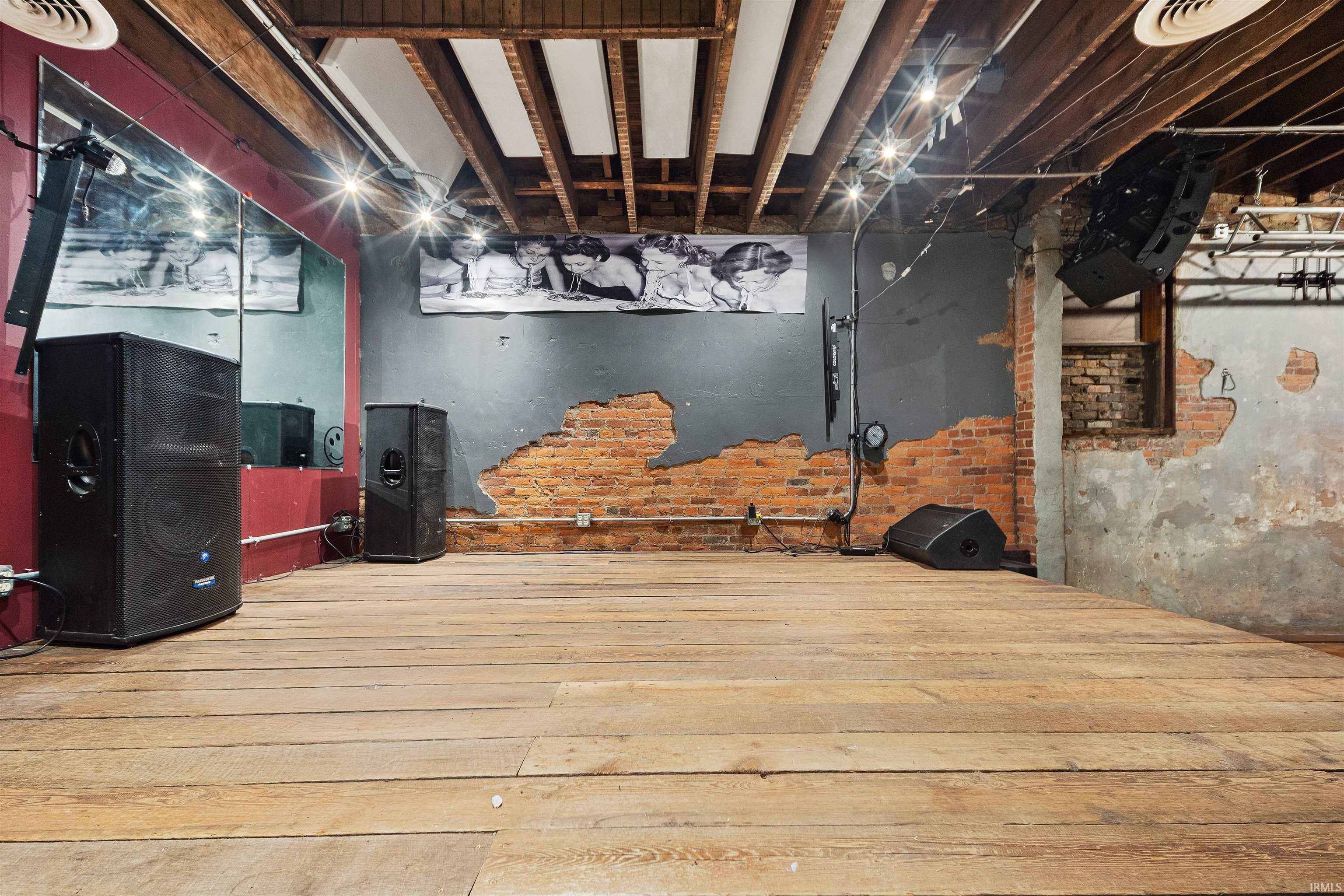 Unfinished basement with hardwood / wood-style flooring