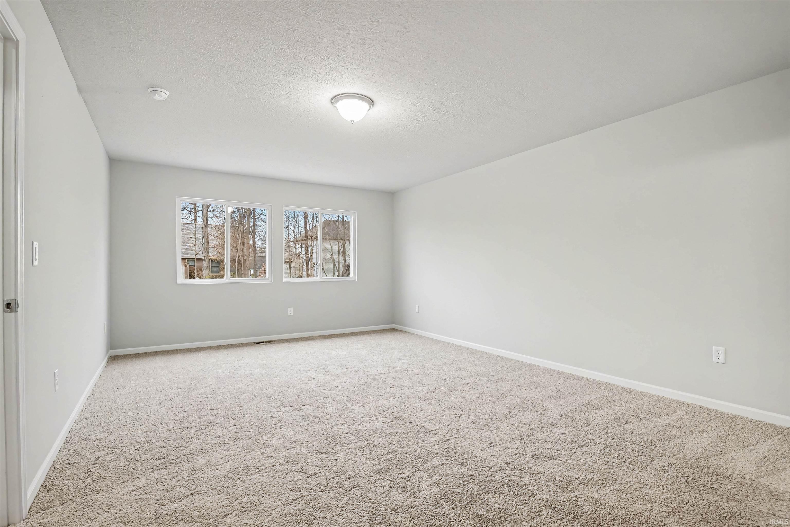 The spacious primary suite abounds with natural lighting. The private spa inspired bath features a large vanity and oversized walk-in closet.