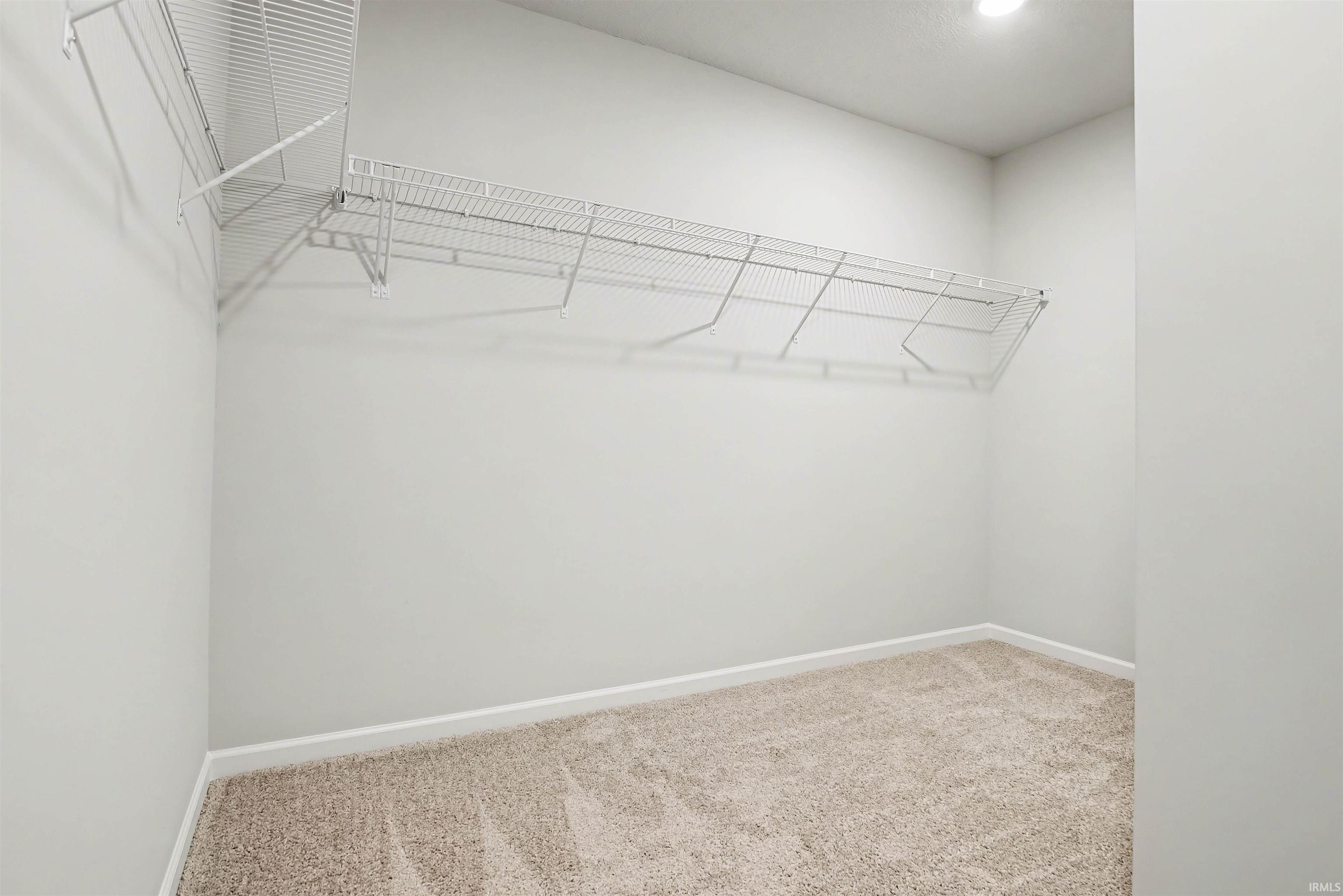 The spacious primary suite abounds with natural lighting and oversized walk-in closet.