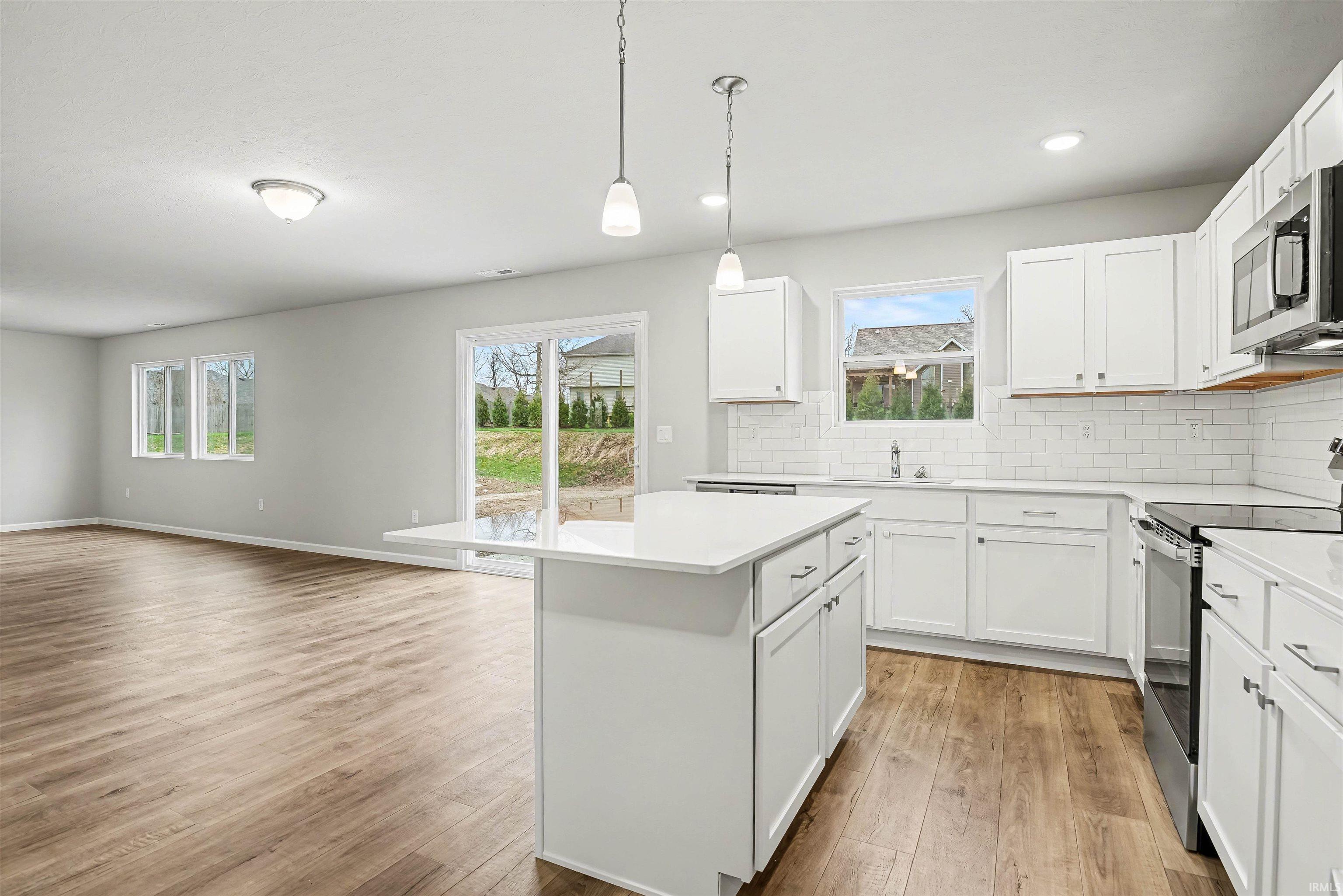 The kitchen is well equipped with quartz counters, island with additional storage & prep space and comprehensive stainless steel appliance package. The slider doors offer access to a 10x10 patio, perfect for outdoor grilling or enjoying a morning coffee