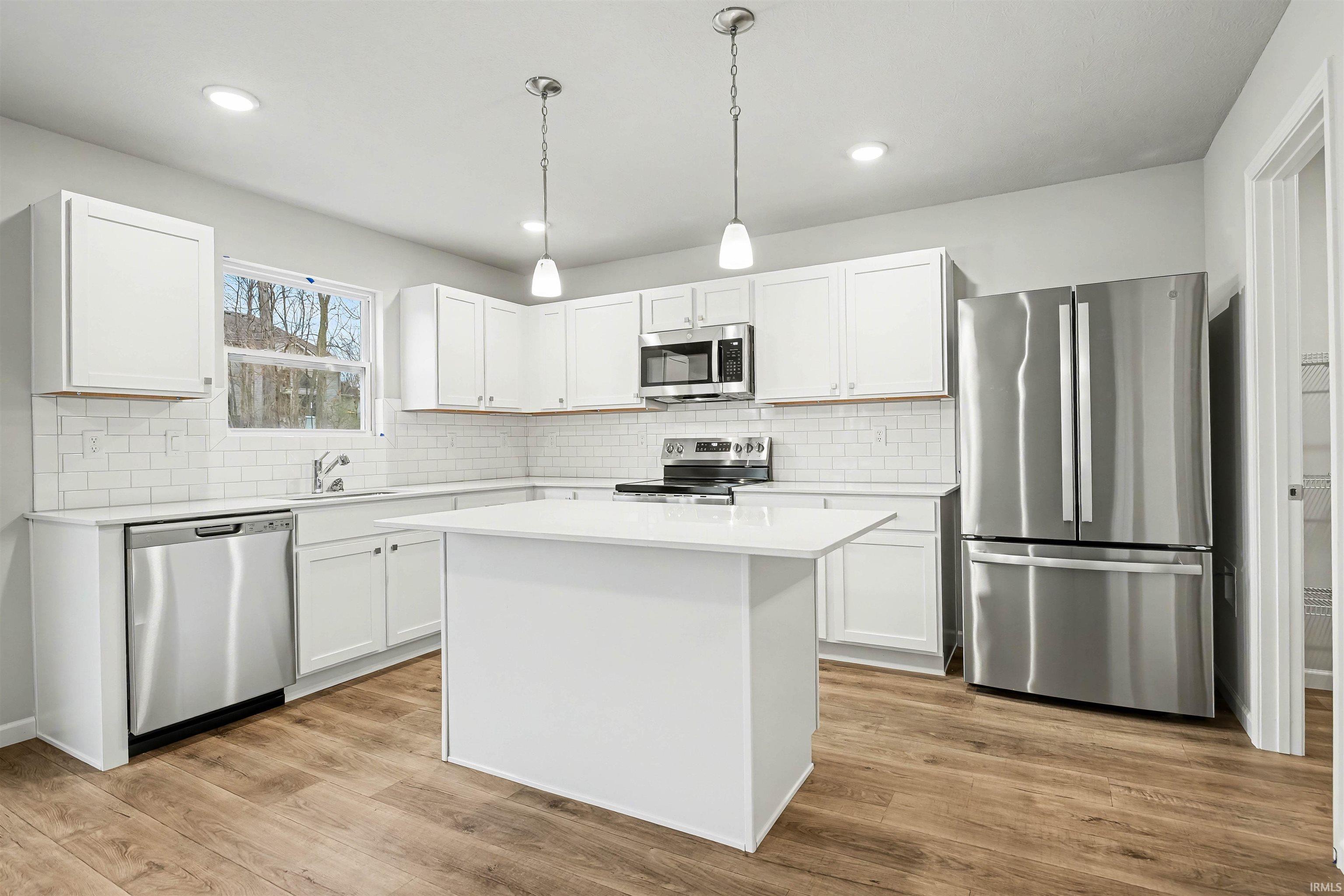 The kitchen is well equipped with quartz counters, island with additional storage & prep space and comprehensive stainless steel appliance package. The slider doors offer access to a 10x10 patio, perfect for outdoor grilling or enjoying a morning coffee