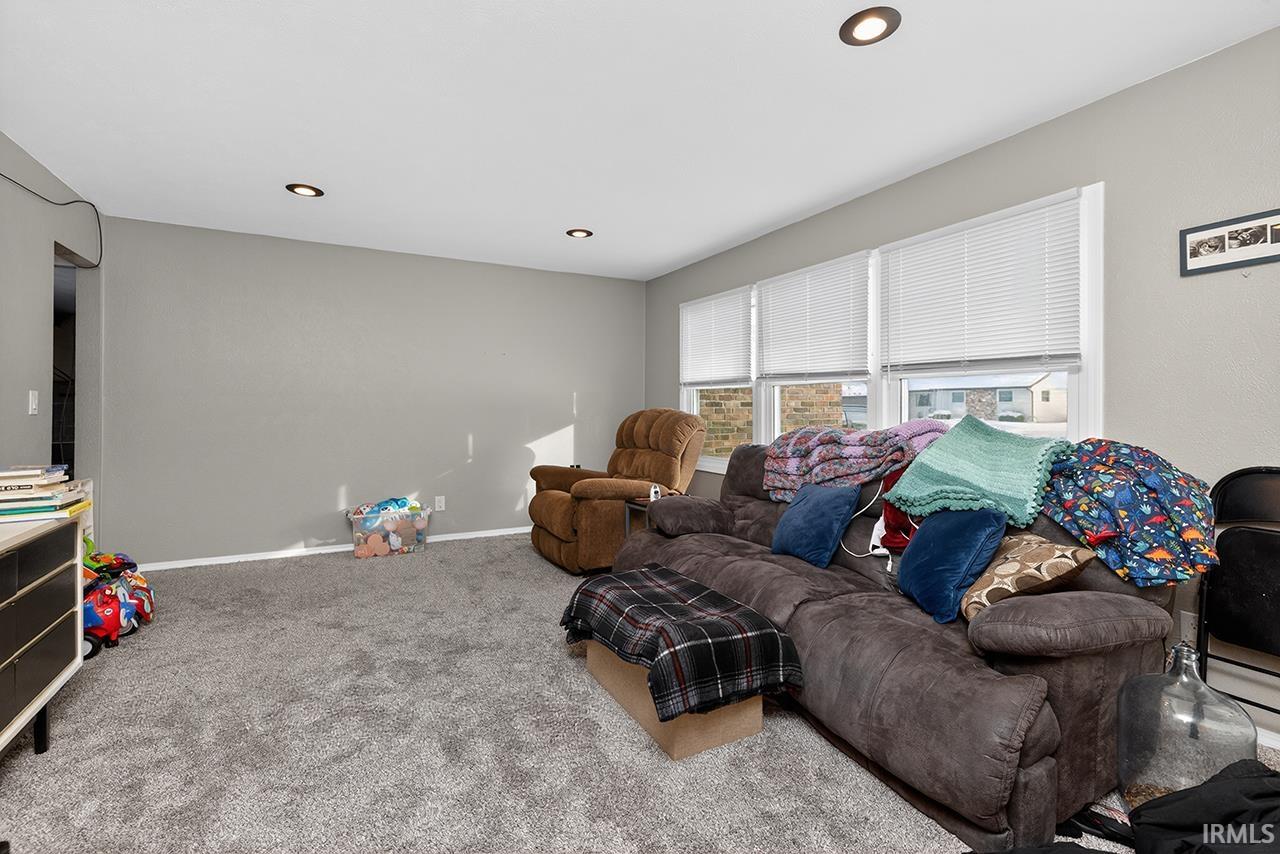 Living area with carpet and recessed lighting