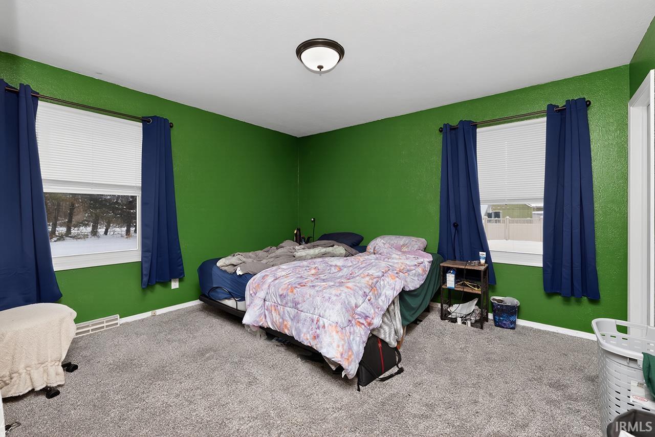 Bedroom with carpet flooring and baseboards
