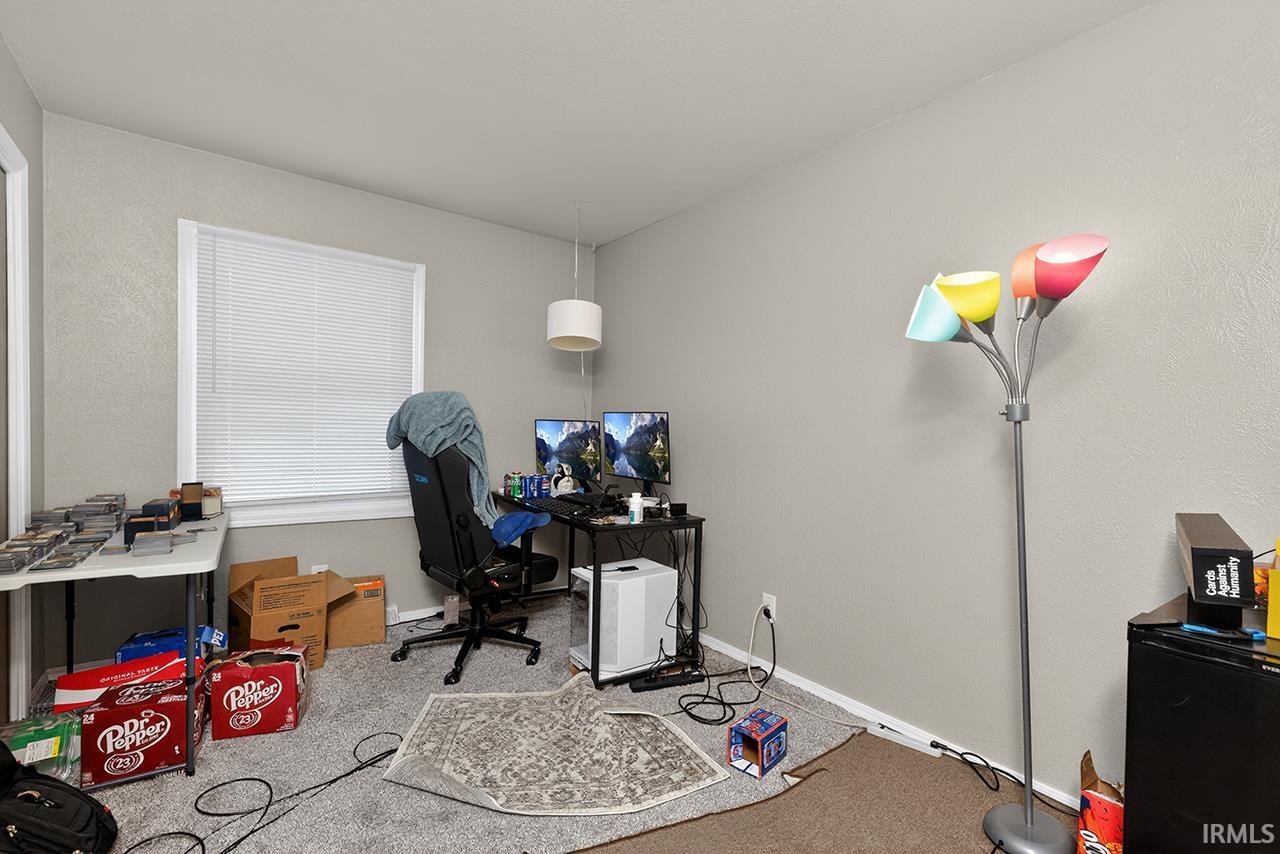 Carpeted office space with baseboards