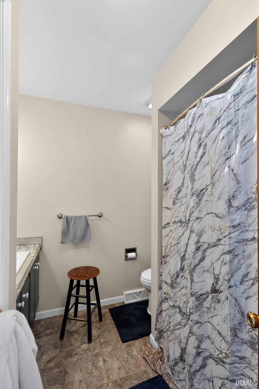 Full bathroom featuring vanity and a shower with shower curtain
