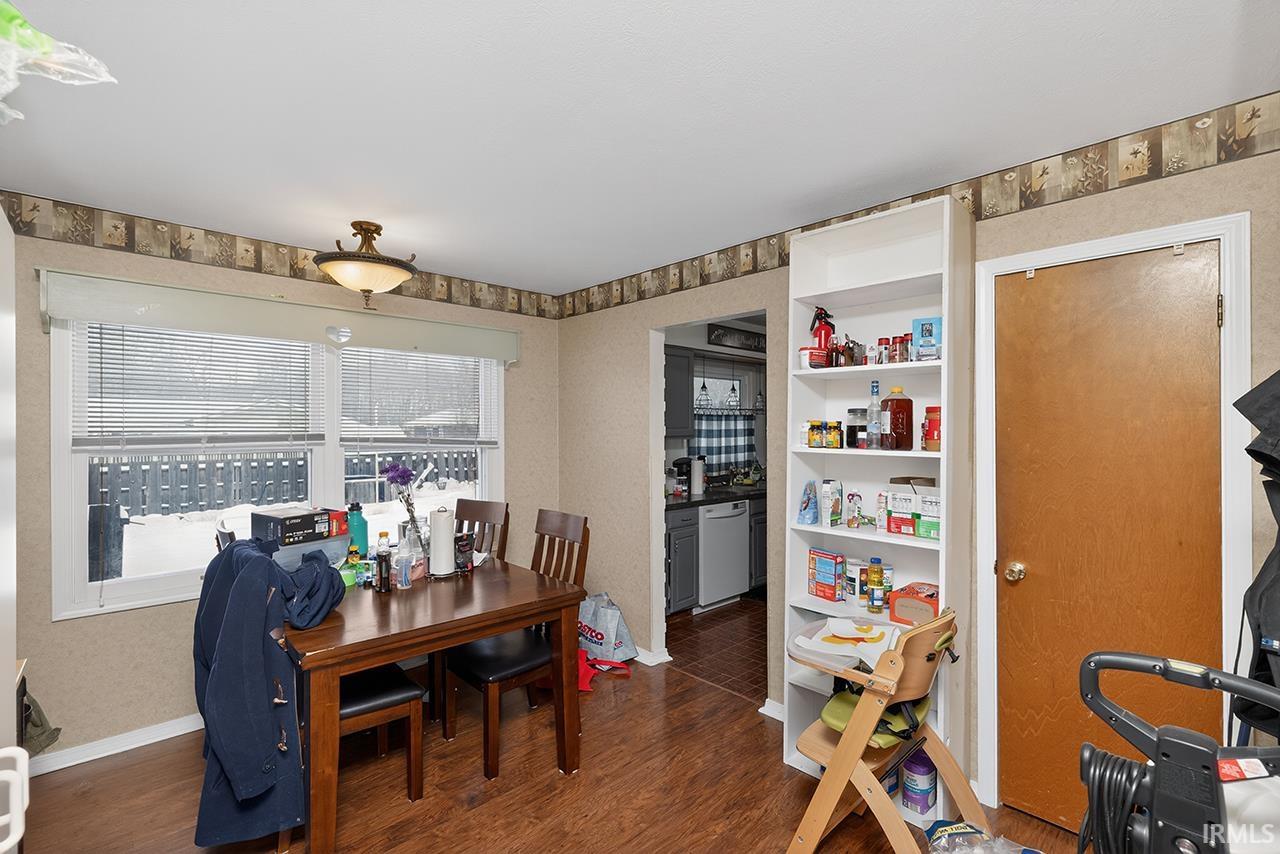Dining room with dark wood-style flooring
