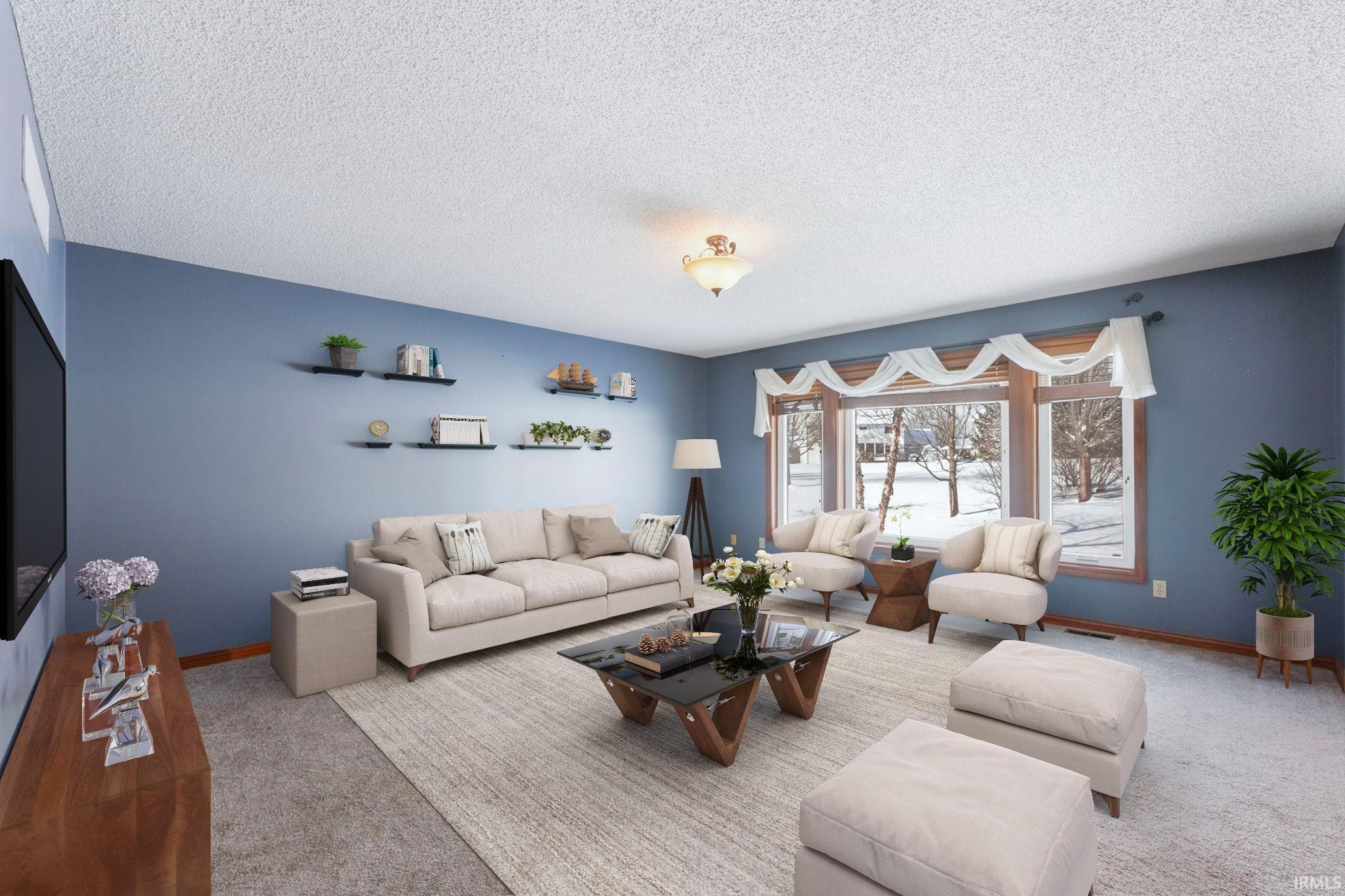 Living area featuring carpet flooring and a textured ceiling