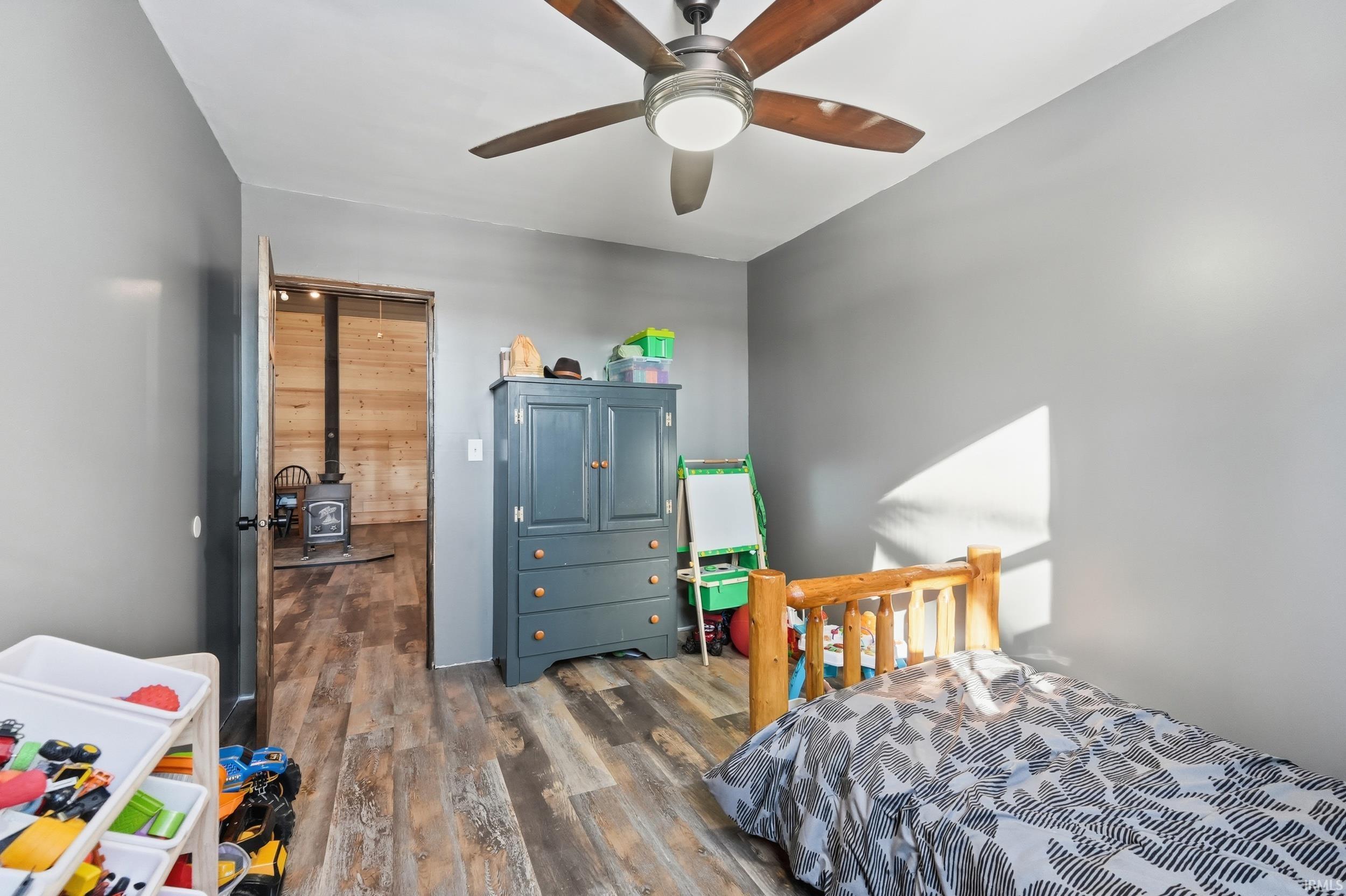 Bedroom featuring dark wood-style flooring and ceiling fan