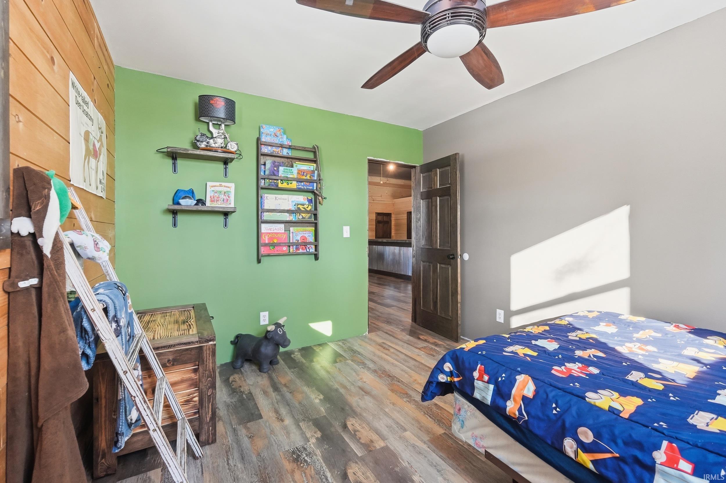 Bedroom featuring wood finished floors and ceiling fan