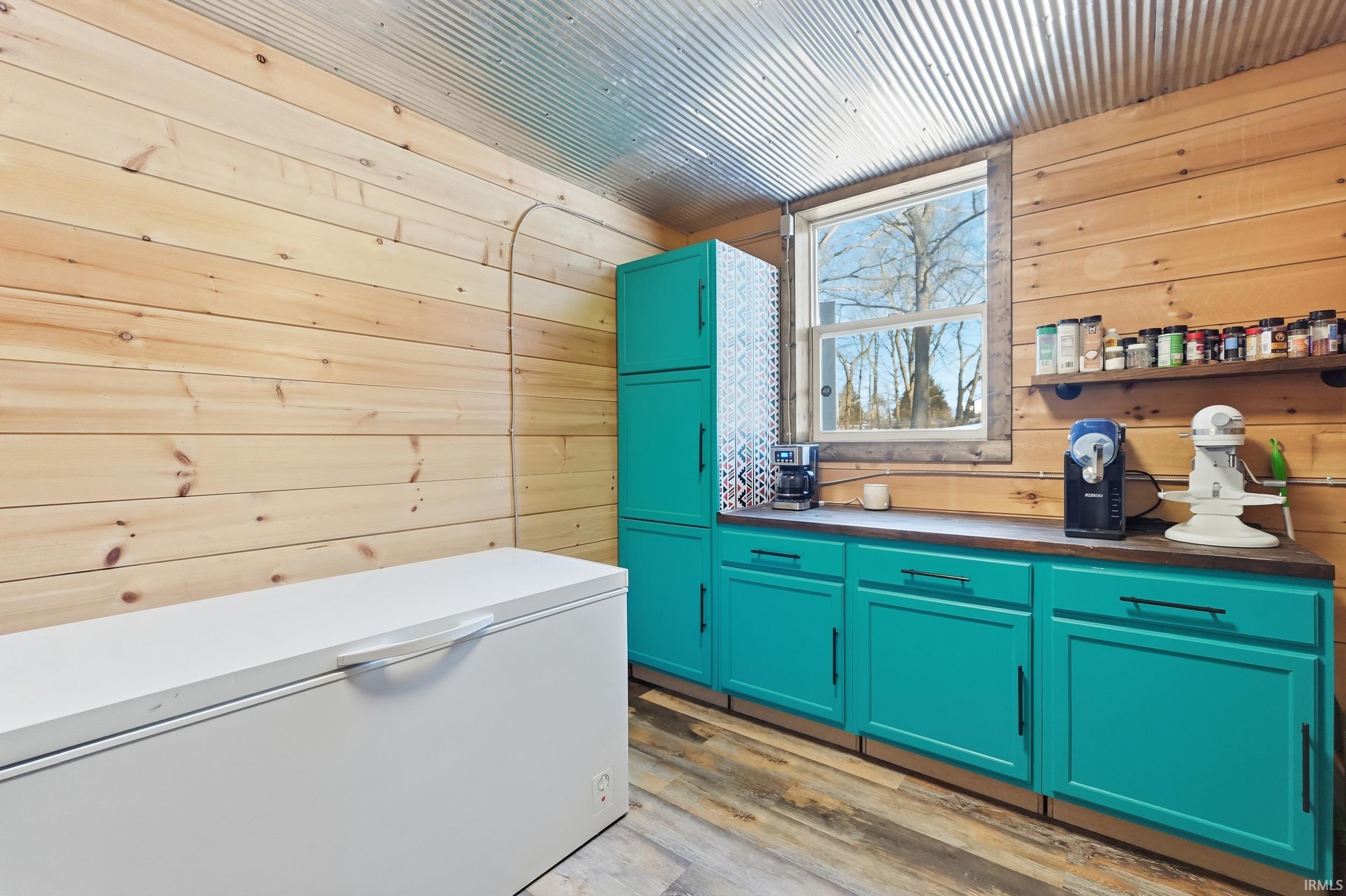 Misc room with wooden walls and light wood-style flooring
