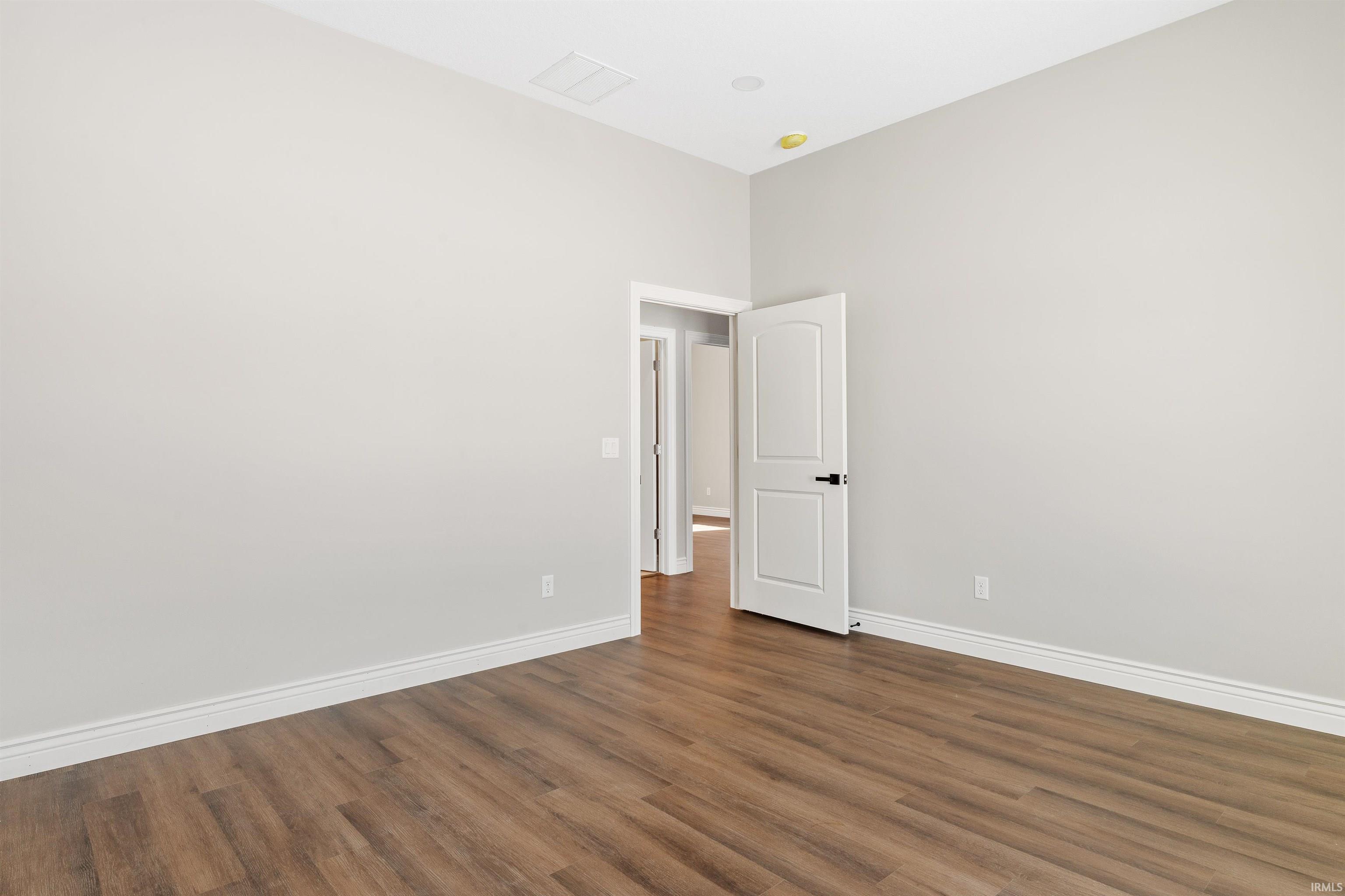 Unfurnished room featuring dark wood-style floors