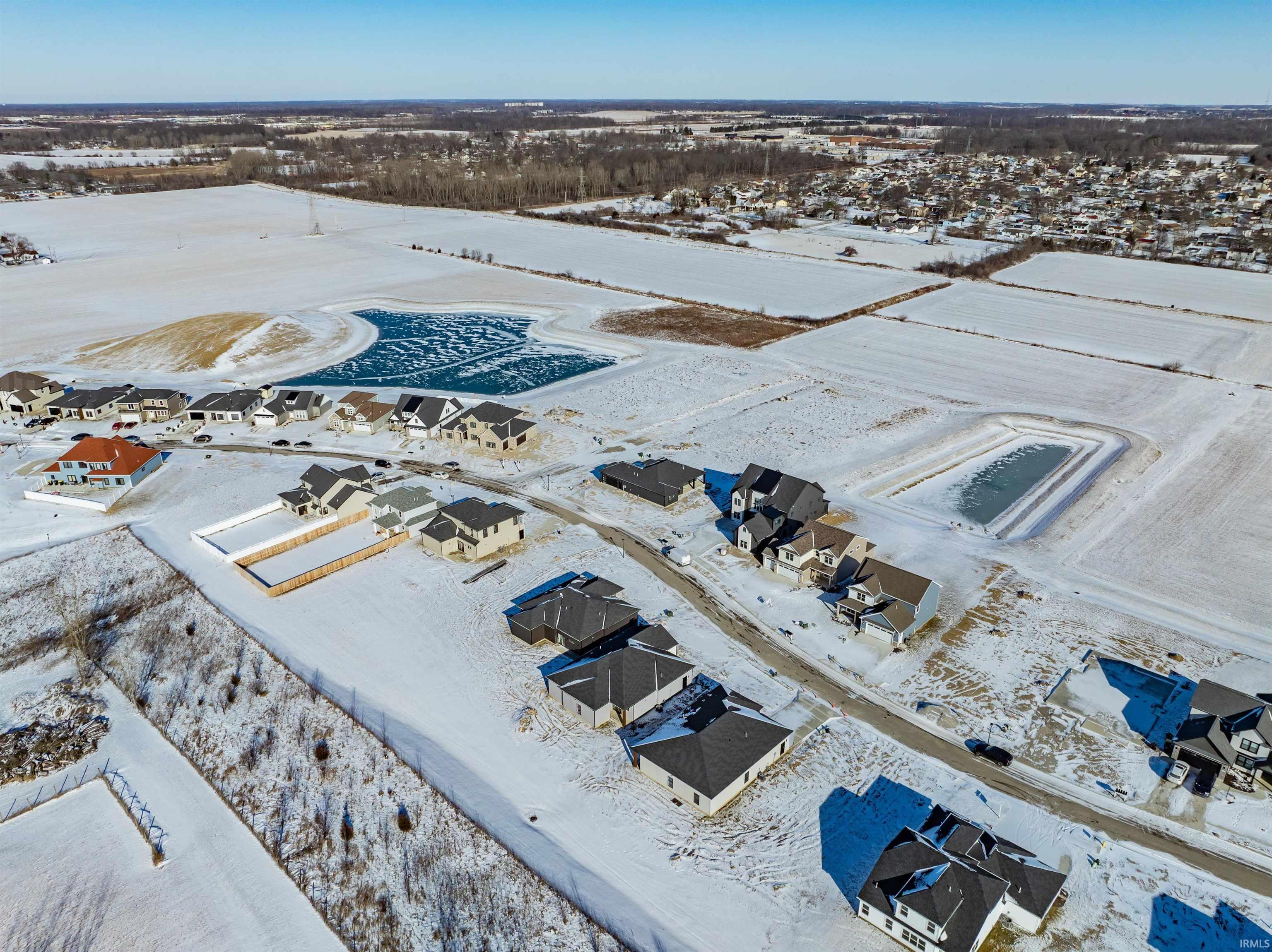 Snowy aerial view featuring a residential view
