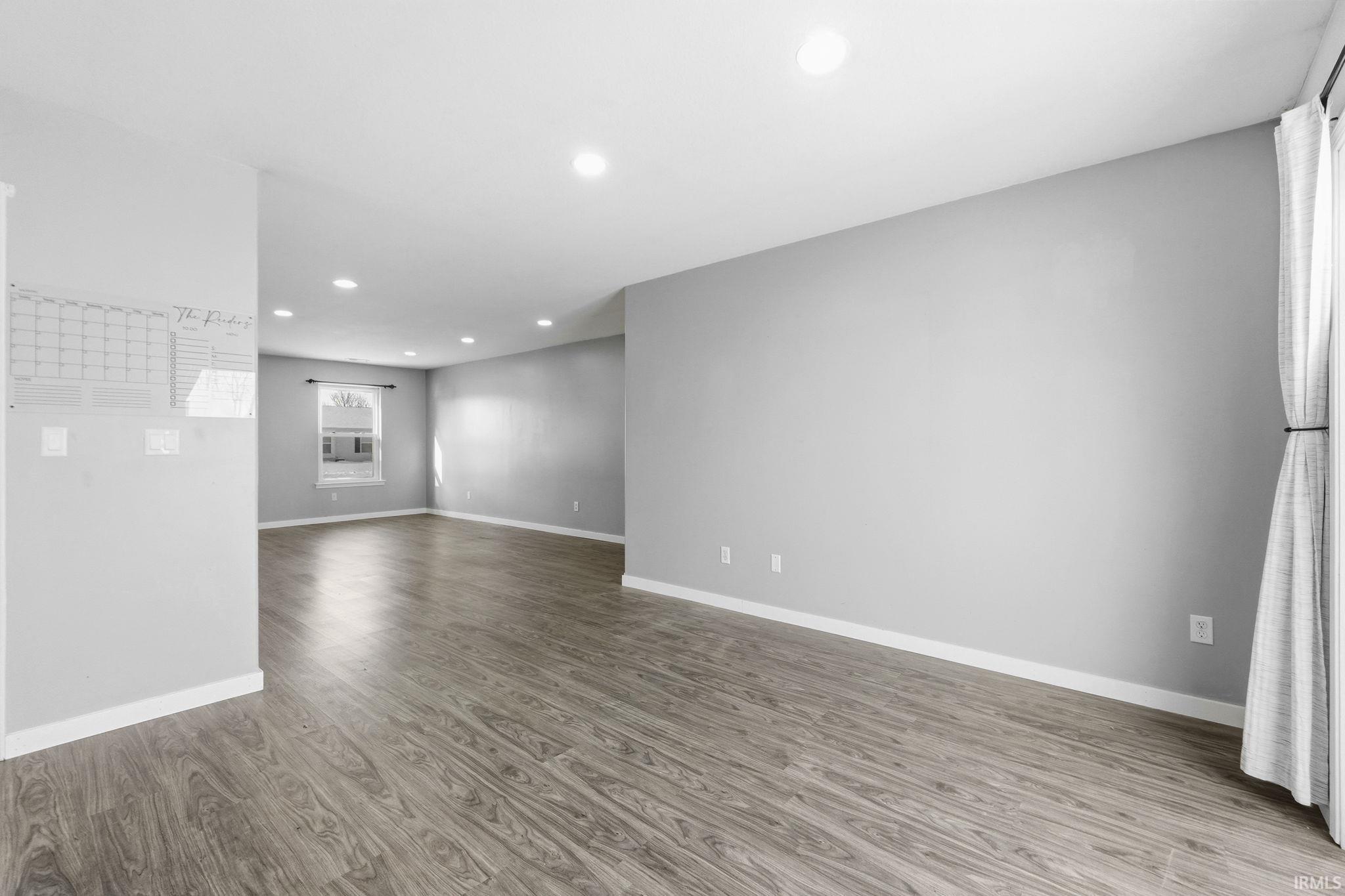 Spare room featuring light wood-type flooring and recessed lighting