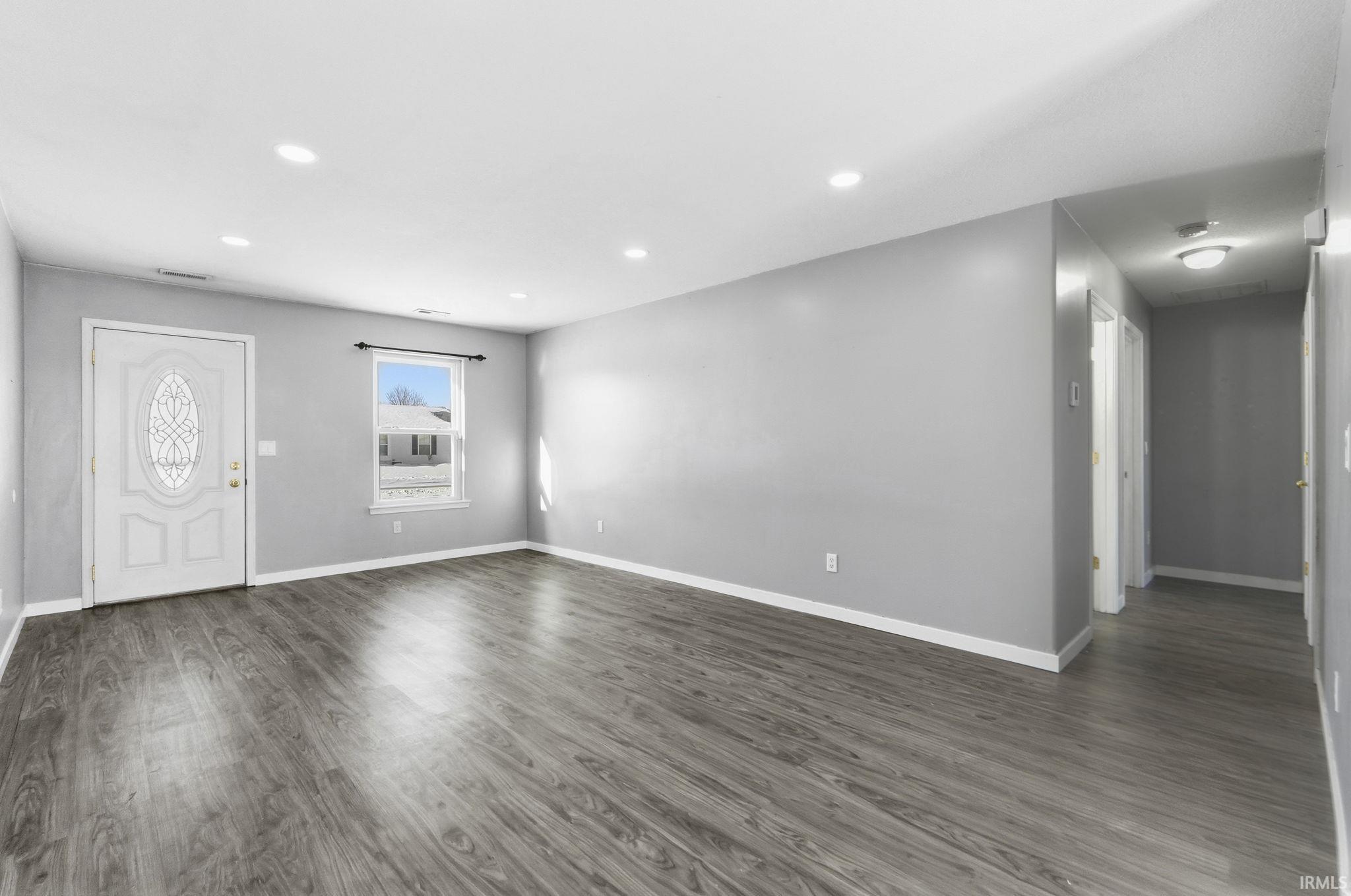 Foyer featuring wood finished floors and recessed lighting