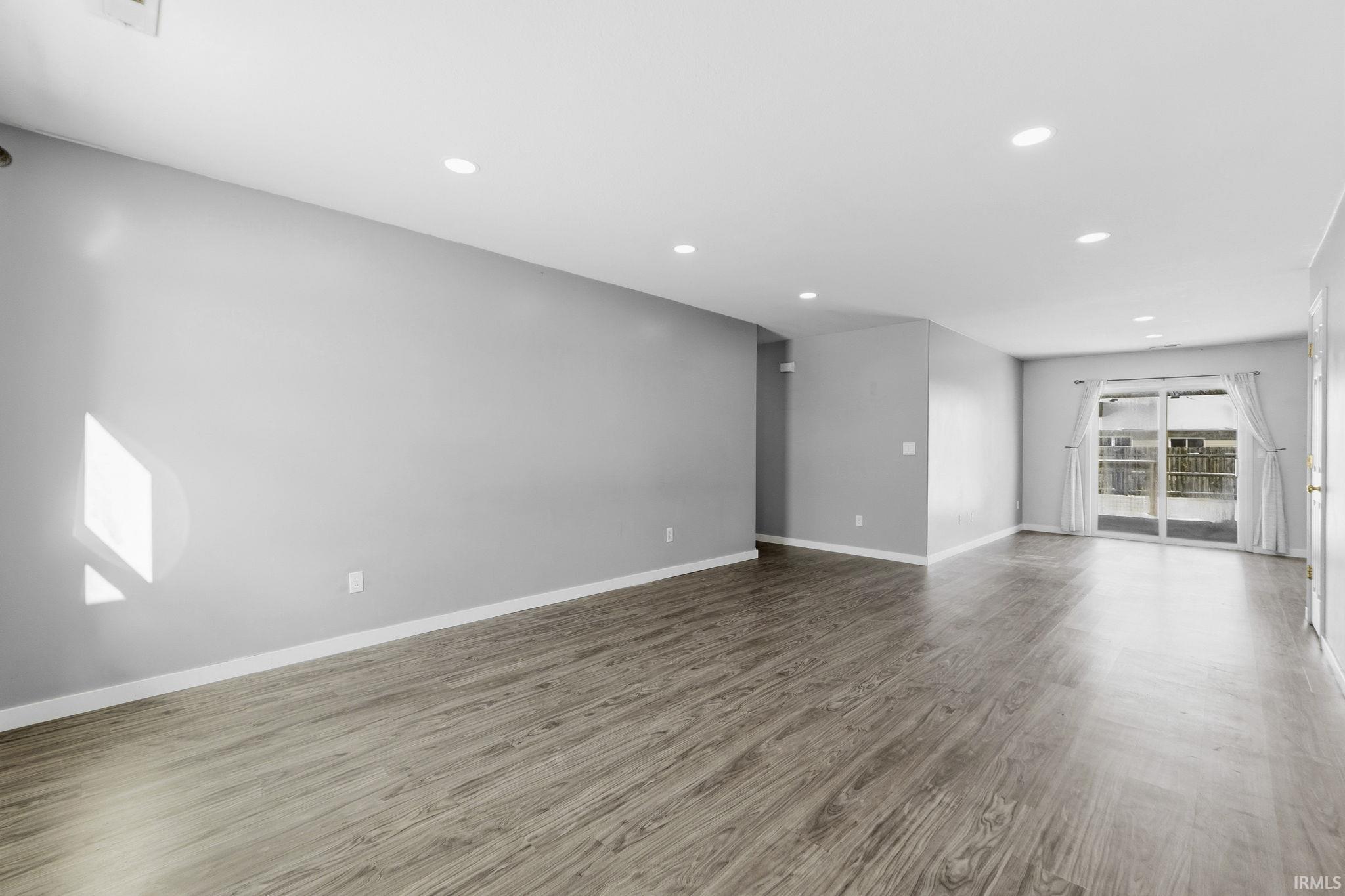Unfurnished room with recessed lighting and wood finished floors