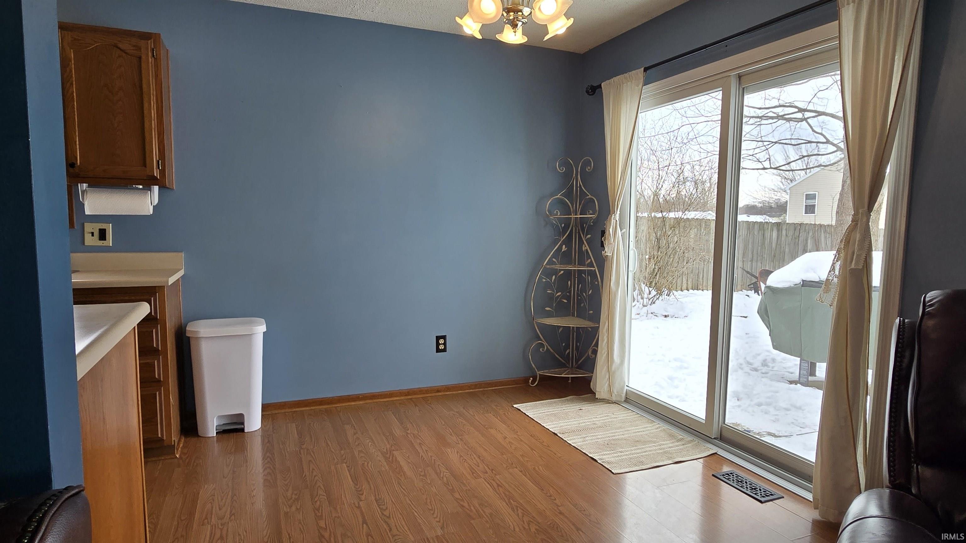 Unfurnished dining area featuring light wood-style floors and a chandelier