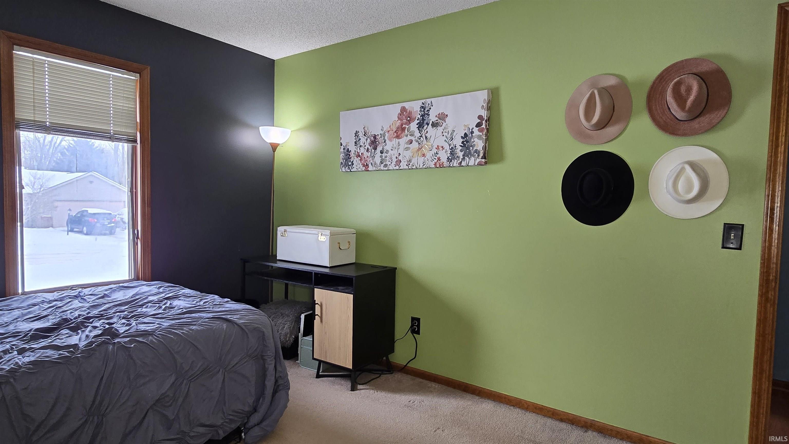 Bedroom with carpet flooring and a textured ceiling
