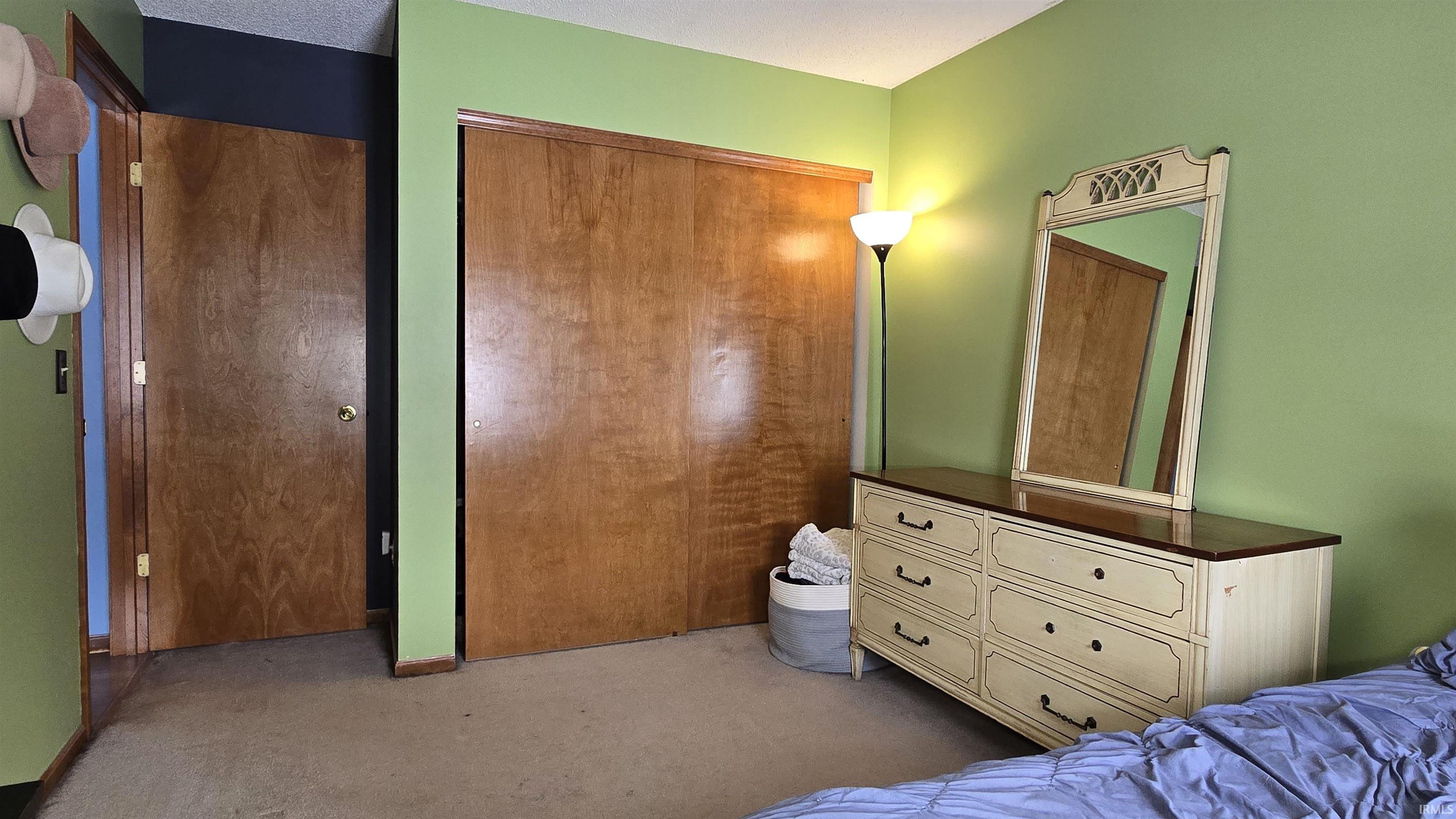 Bedroom featuring a closet and dark carpet