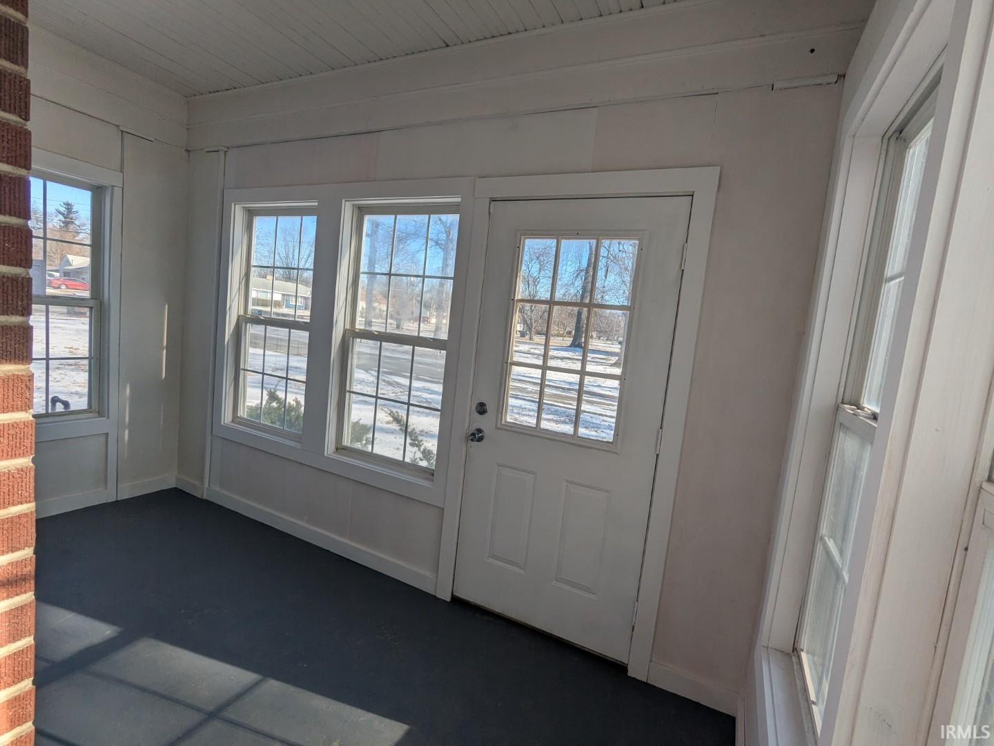 Entryway featuring baseboards and carpet floors