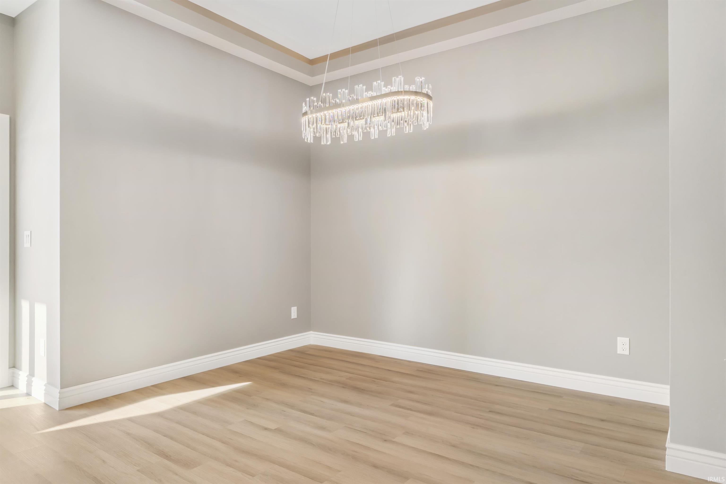 Empty room featuring wood finished floors and baseboards