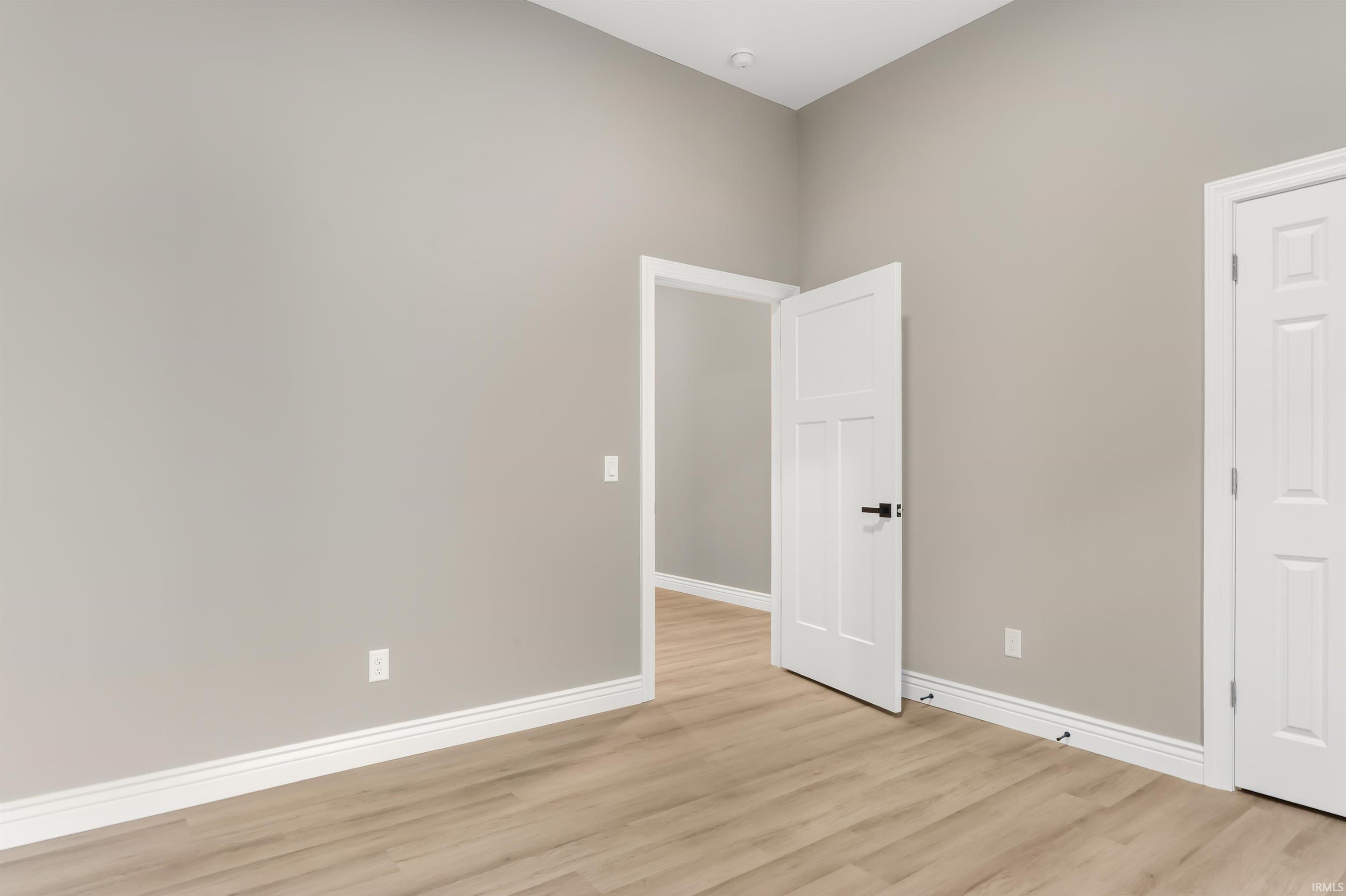 Unfurnished room with baseboards and light wood-style floors