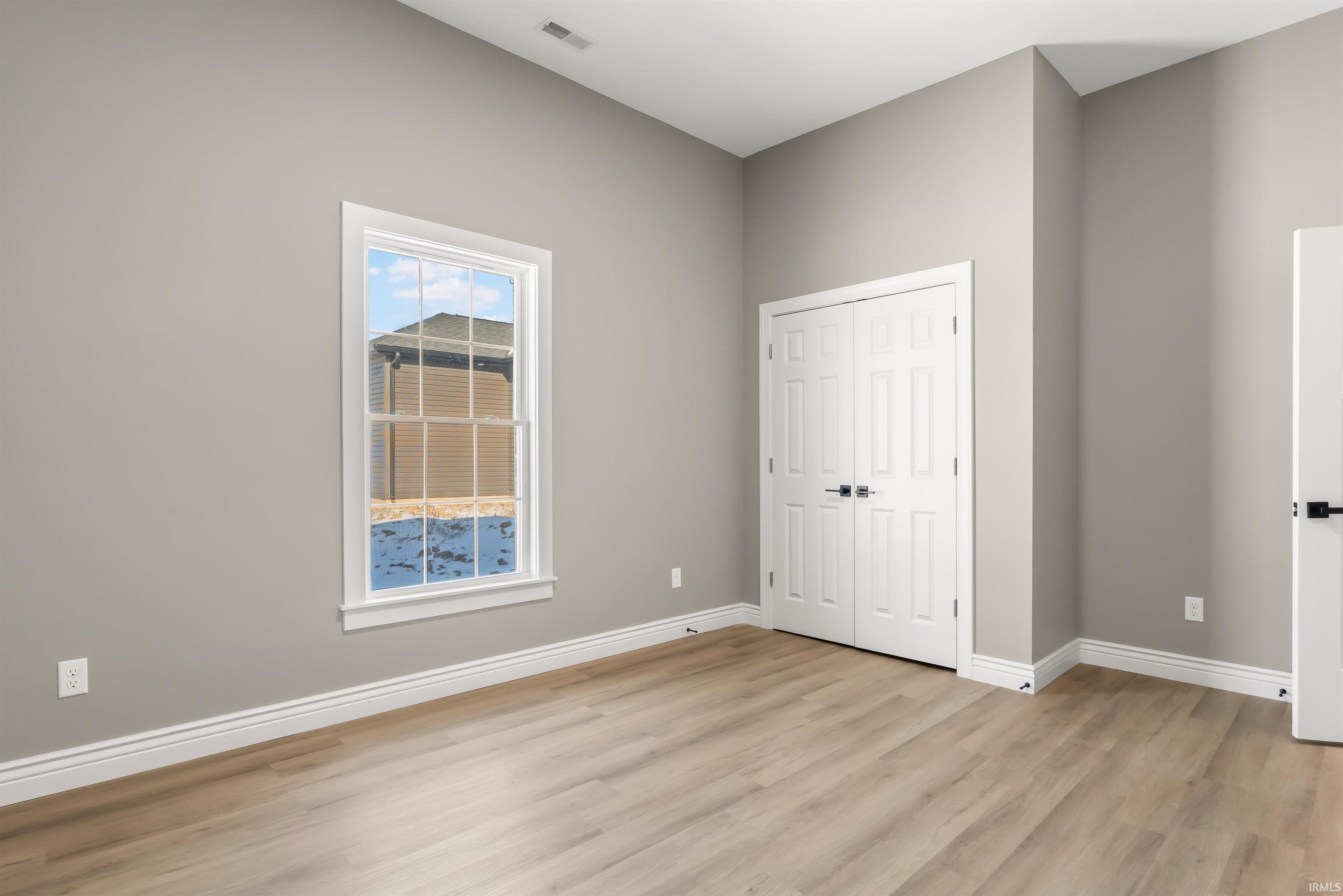 Unfurnished bedroom with a closet and light wood finished floors