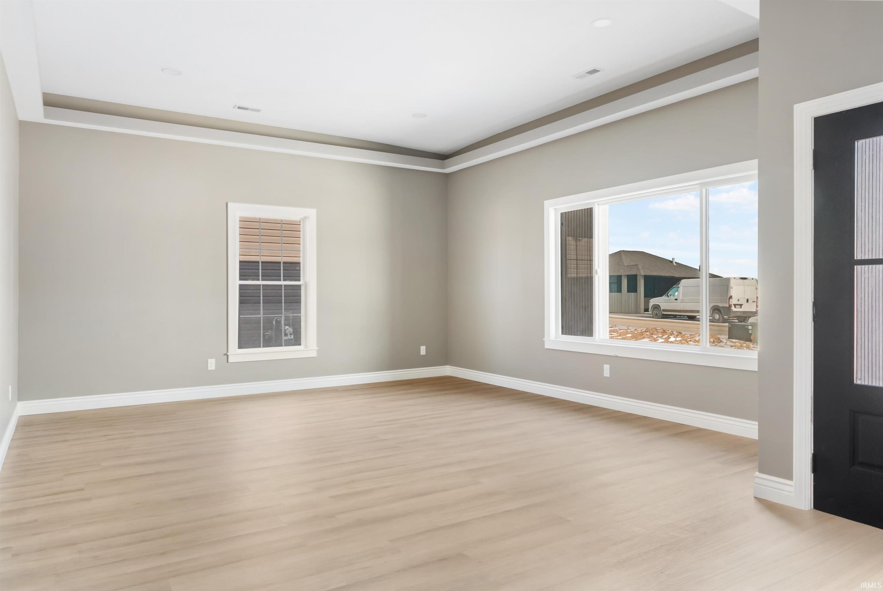 Spare room featuring light wood finished floors and baseboards