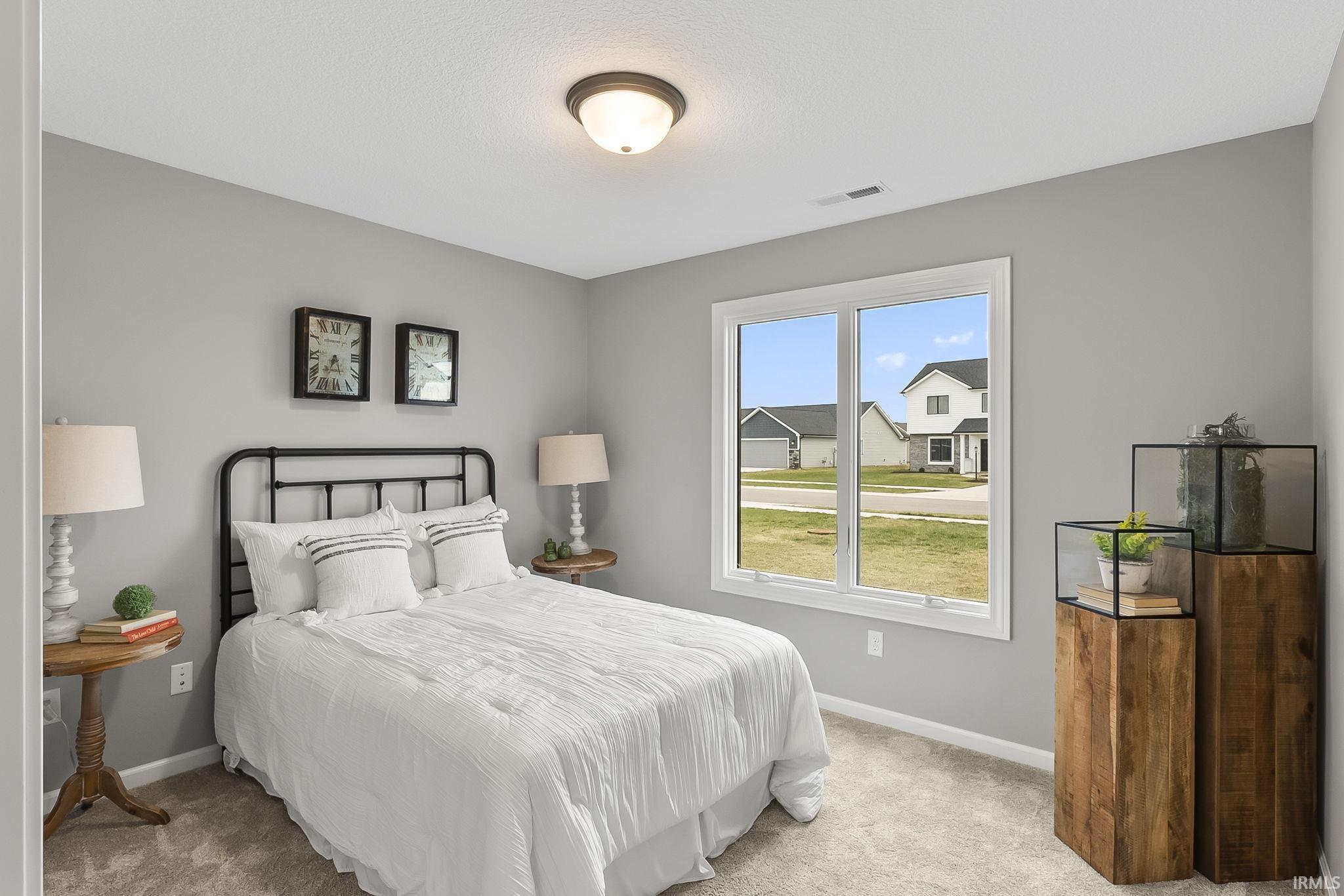 Bedroom featuring carpet floors and baseboards