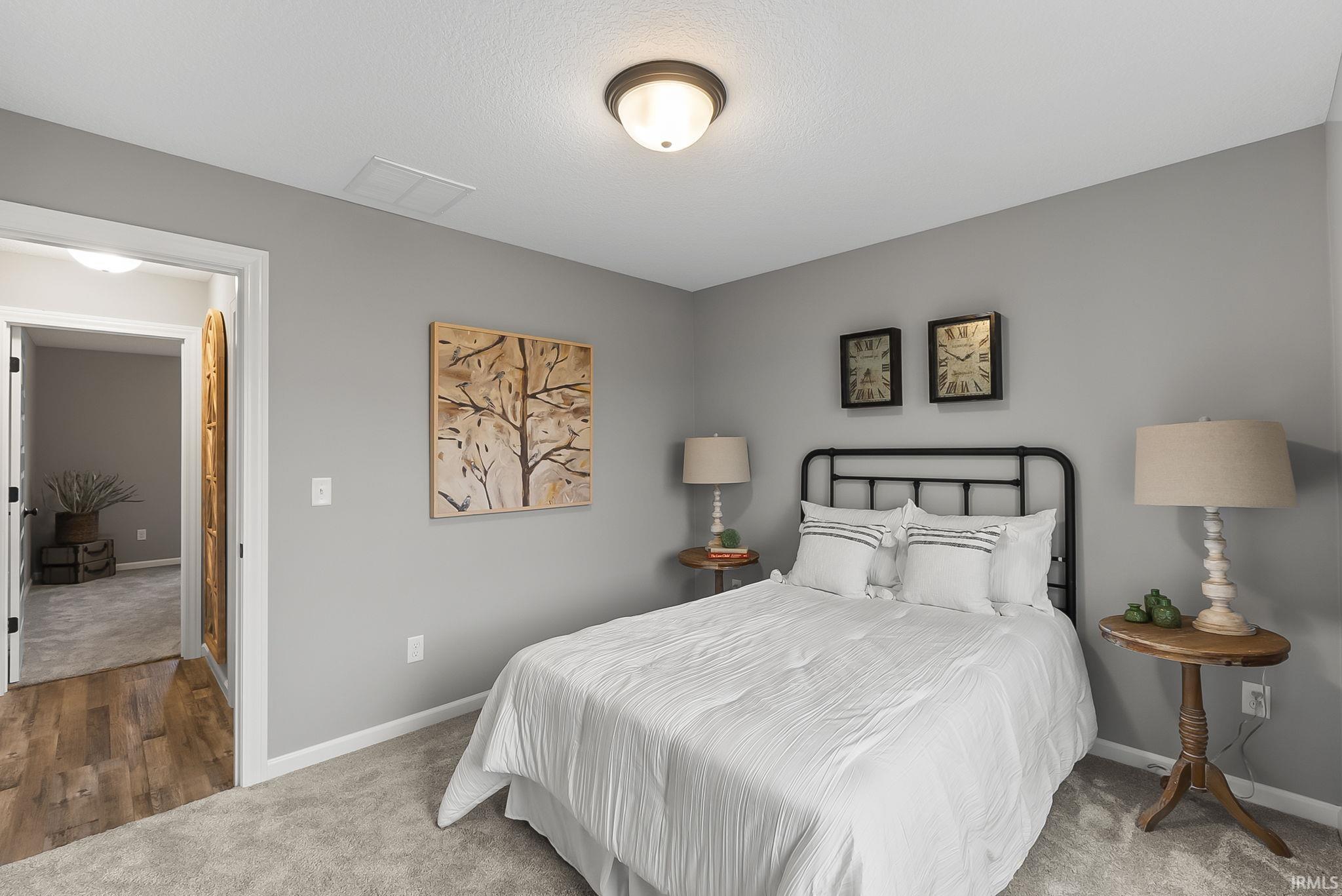 Carpeted bedroom featuring baseboards