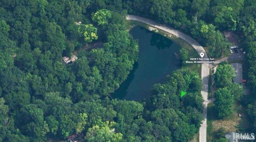 Aerial overview of property's location featuring a heavily wooded area