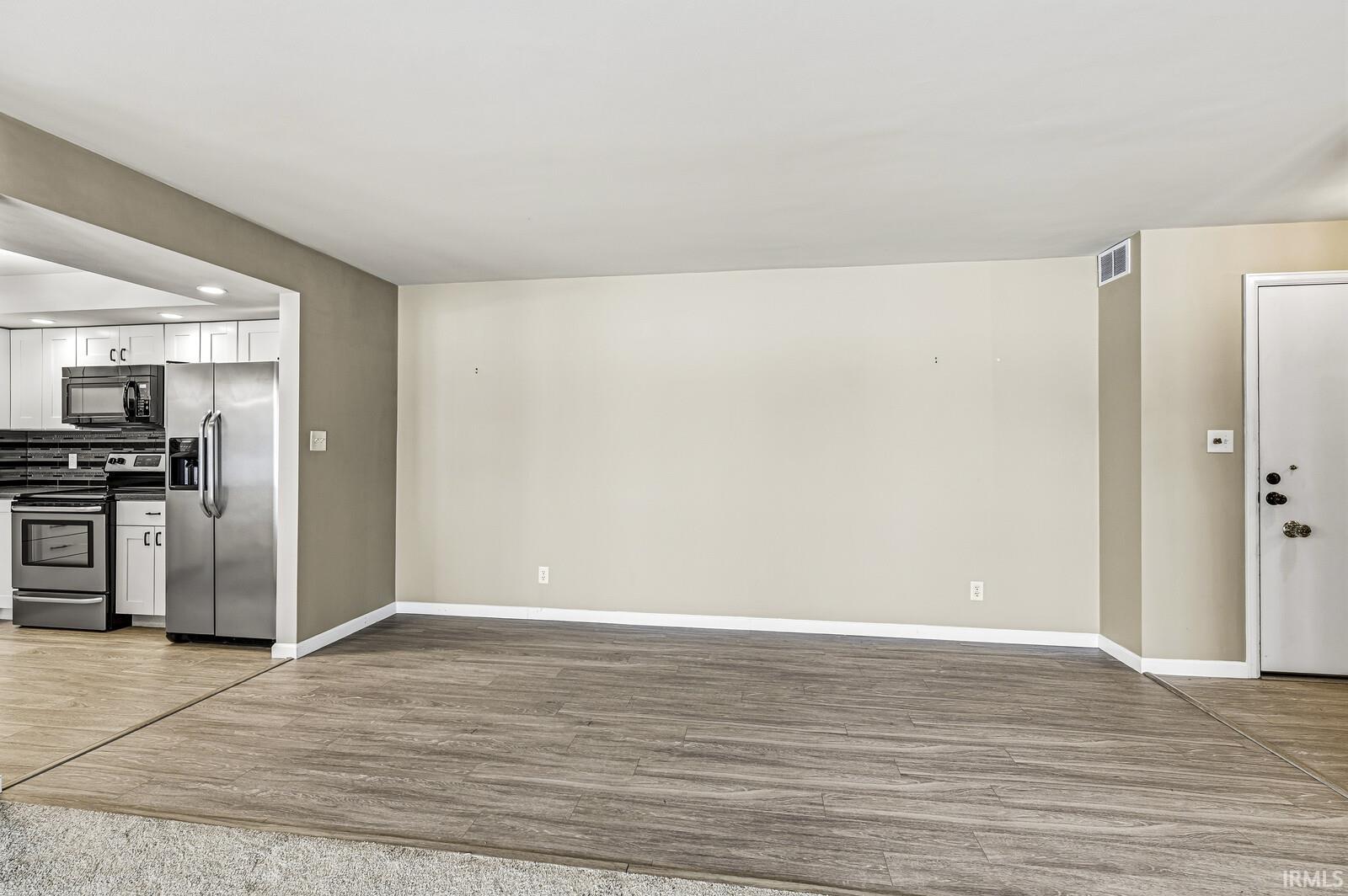Unfurnished living room with light wood-style floors and recessed lighting