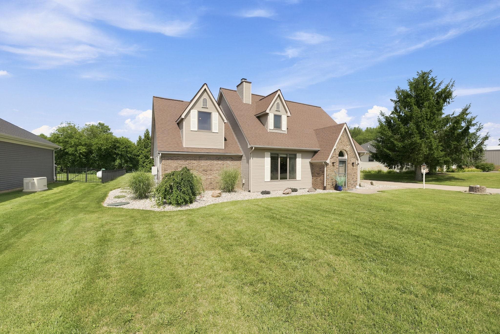 Spacious front yard featuring a manicured lawn