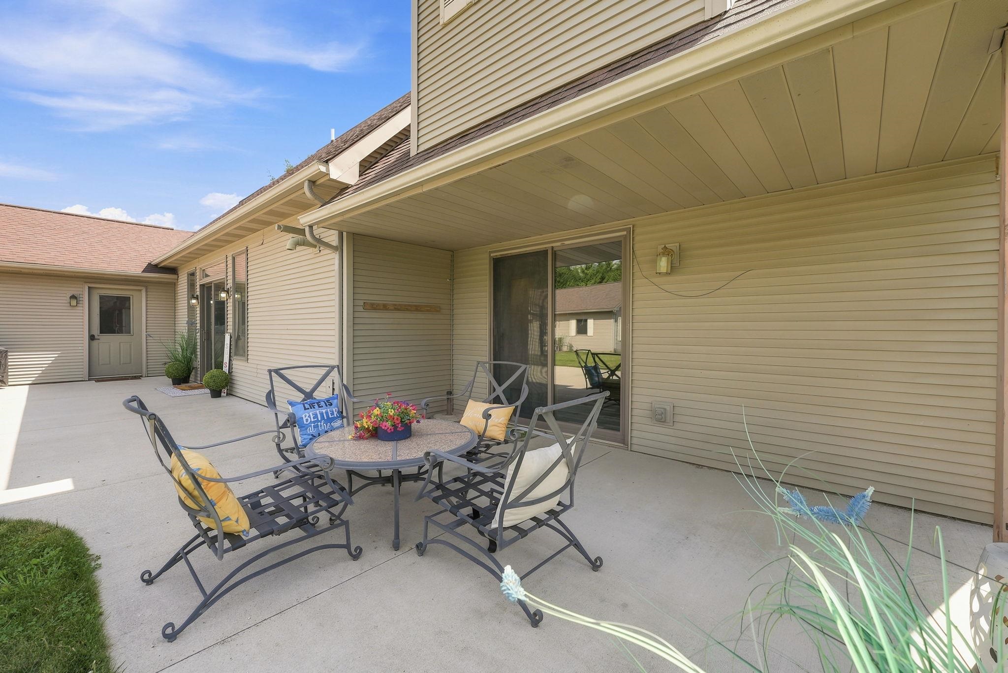 Expansive concrete patio with a covered section