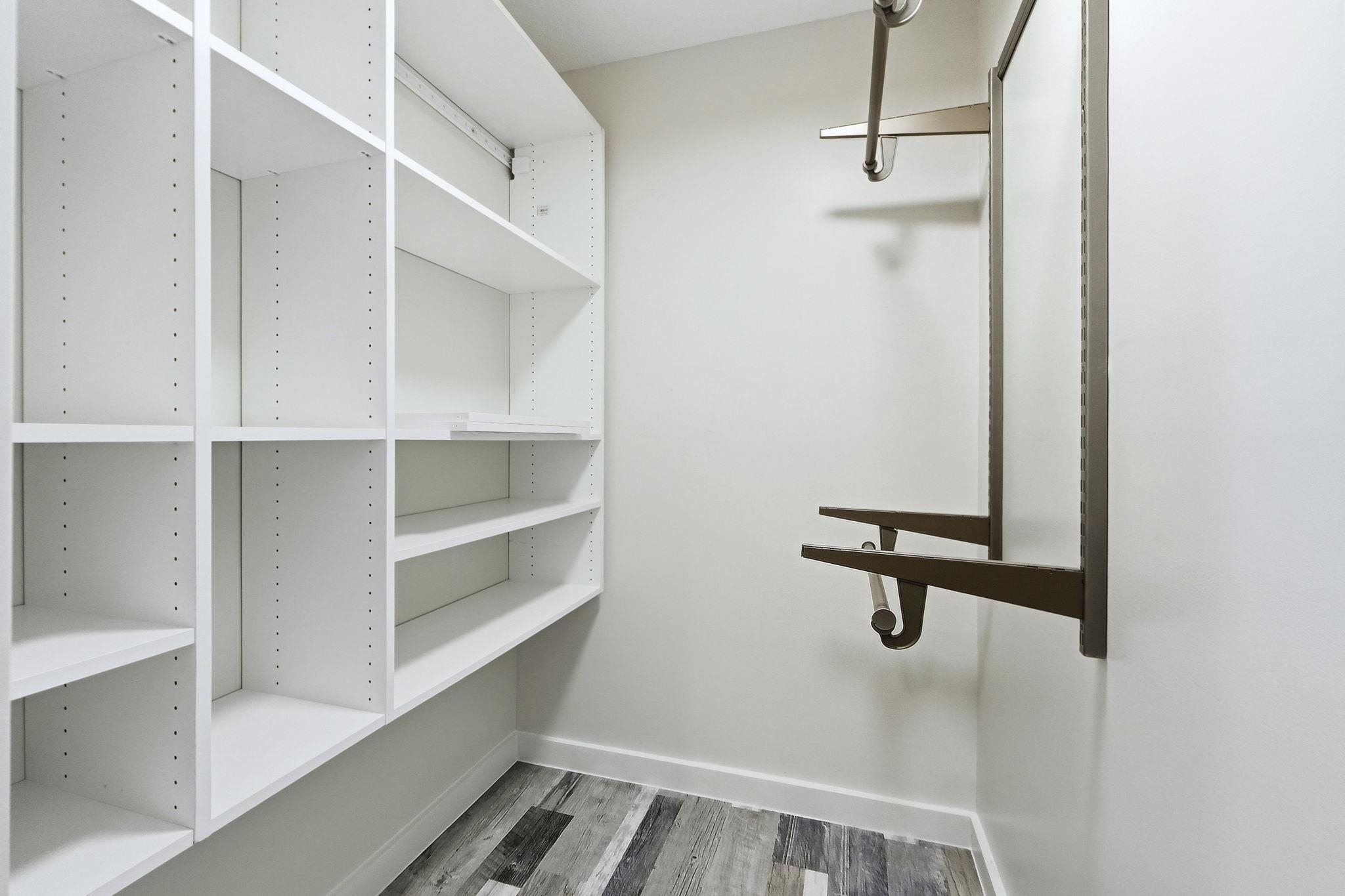 Walk in closet with light wood-style flooring