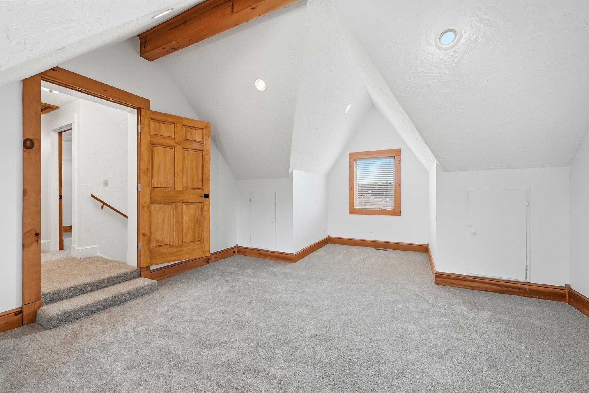 Bonus room 2nd Floor , featuring a vaulted ceiling with exposed wood beams, recessed lighting,   windows with wood trim and brand new carpet
