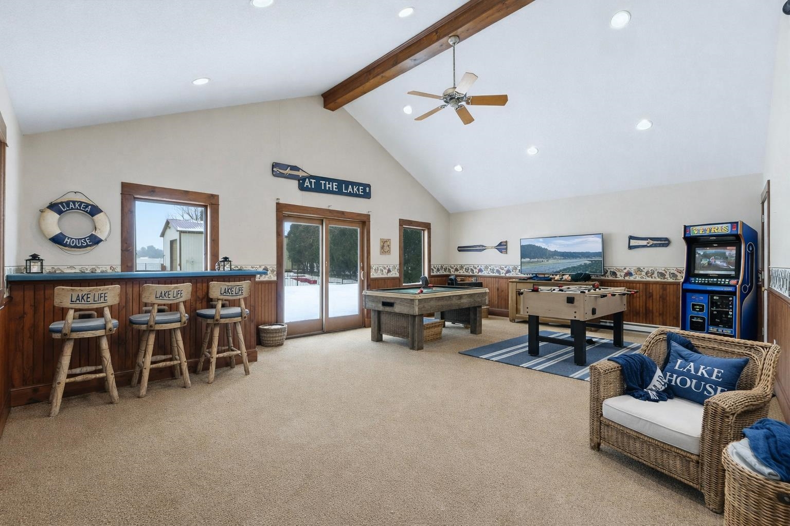 AI furniture staged game room off a detached garage with sliding patio door