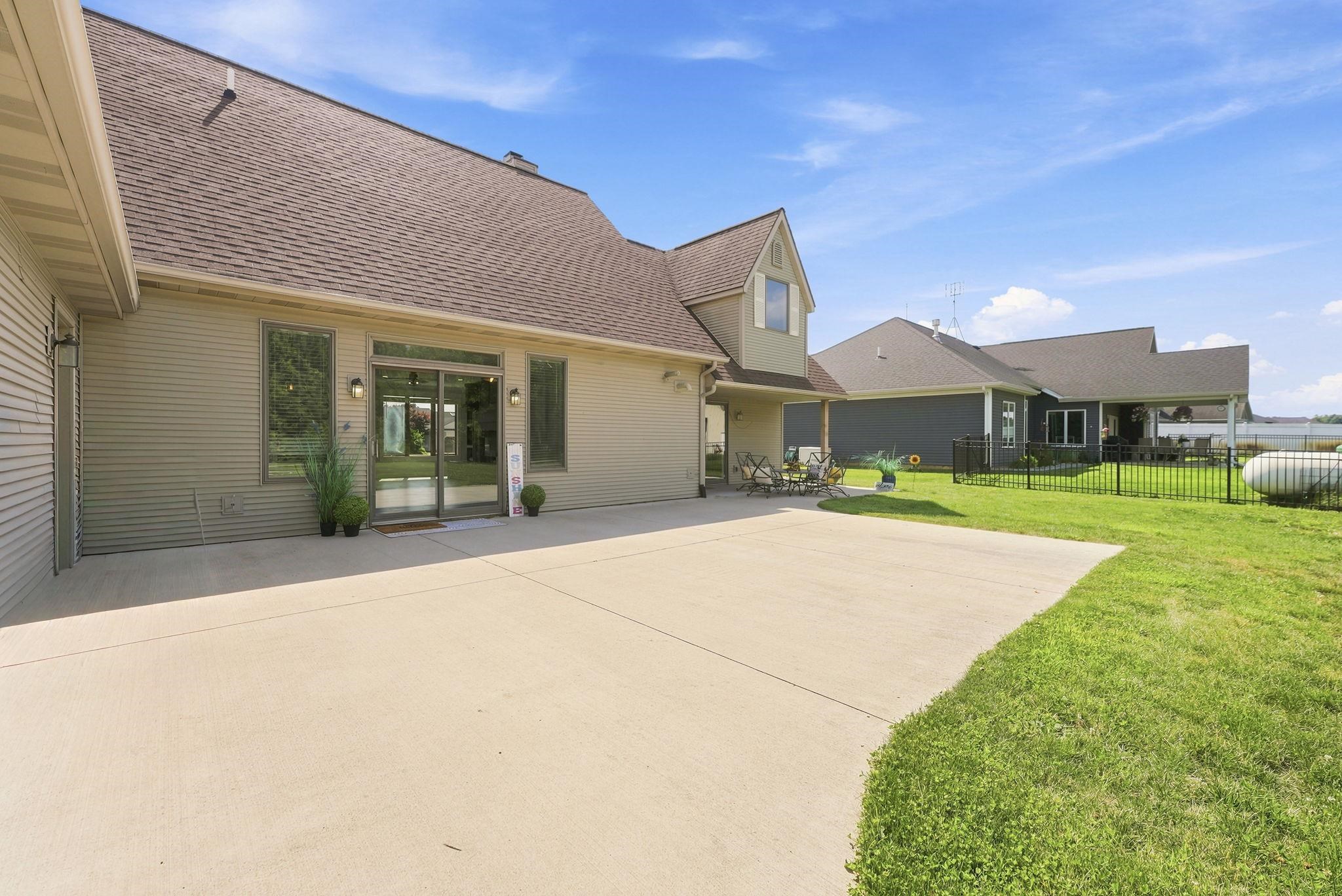 Expansive concrete patio offering ample outdoor living space