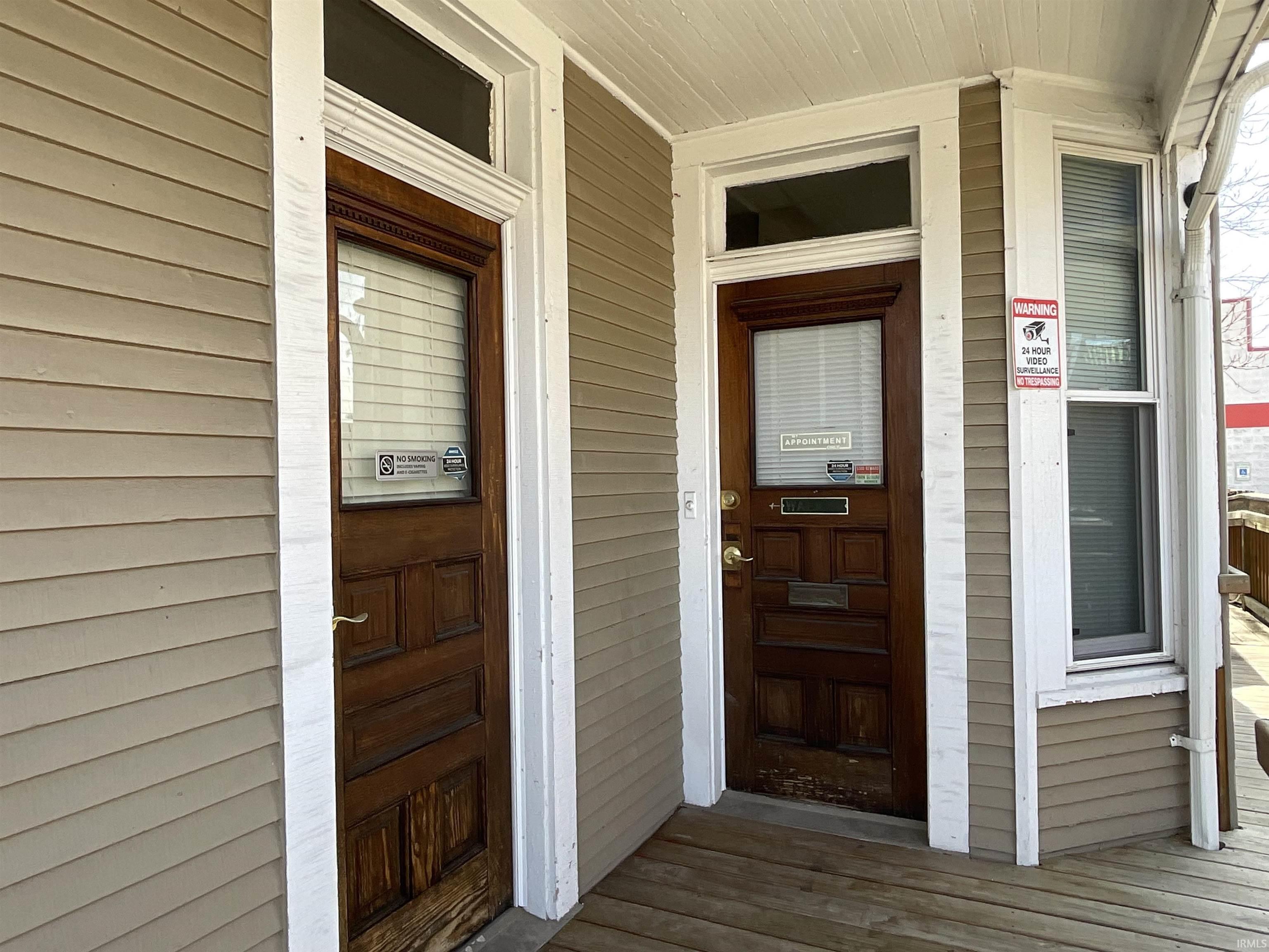 View of exterior entry with covered porch