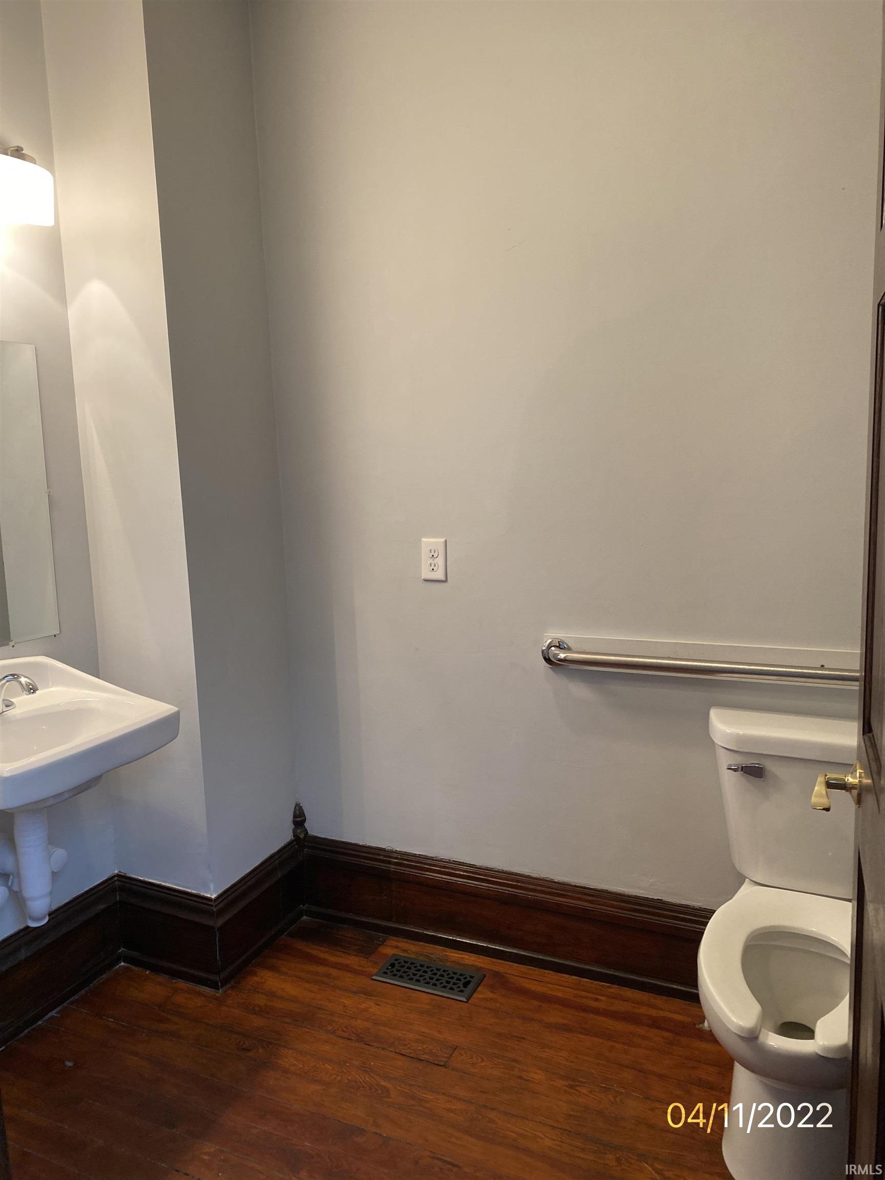 ADA Bathroom with dark wood flooring