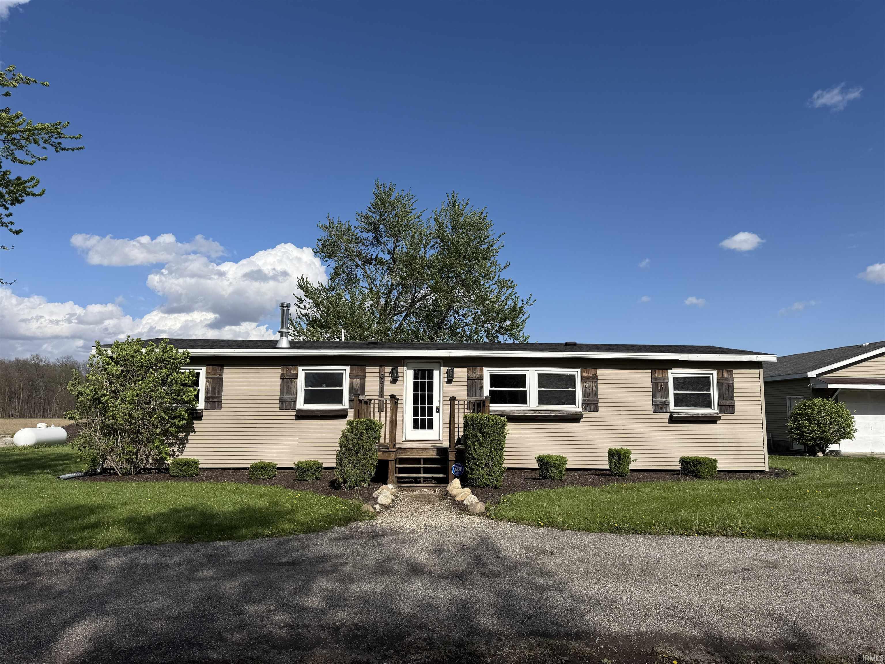 Single story home featuring a front lawn