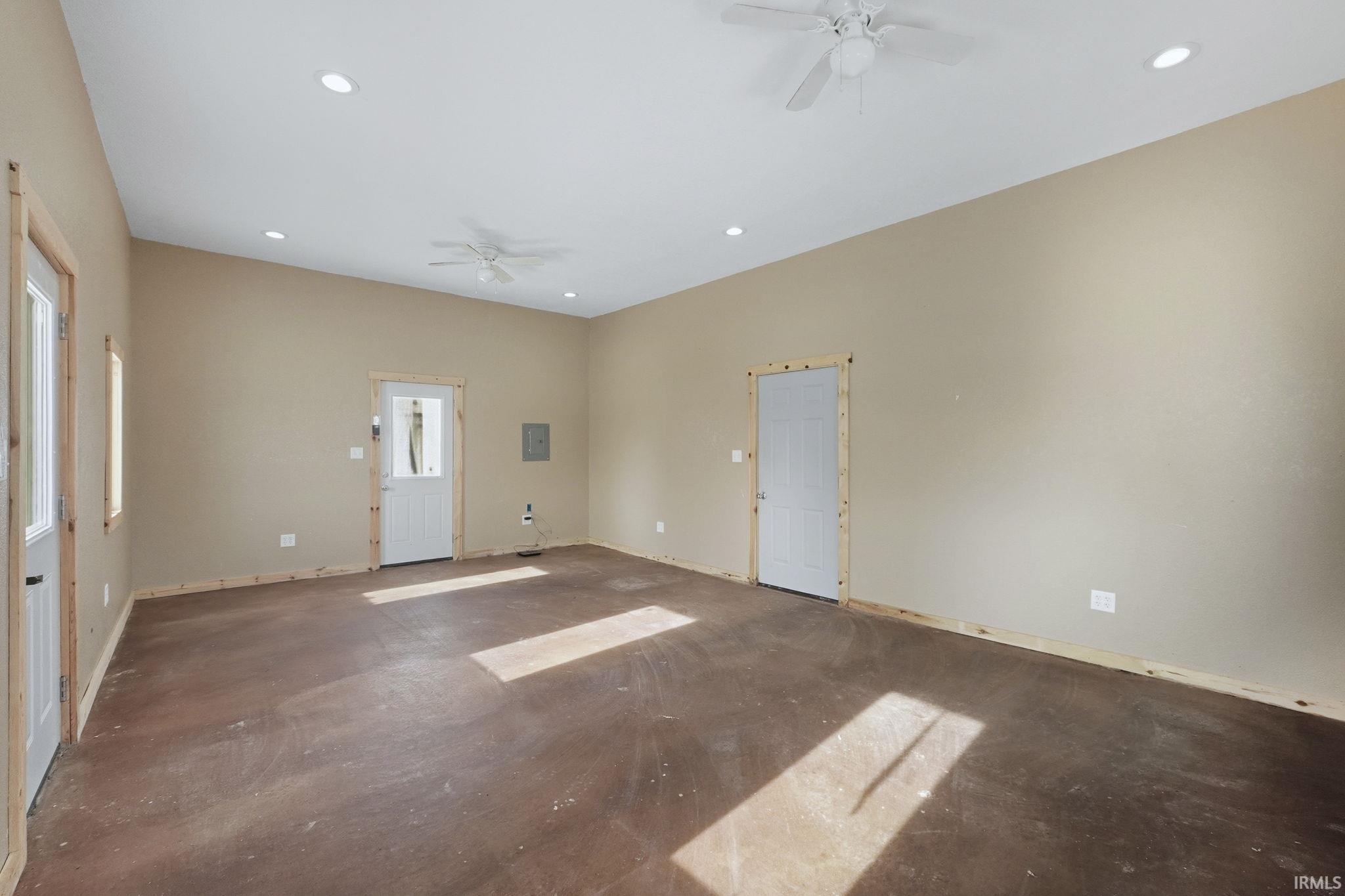Unfurnished living room featuring a ceiling fan and recessed lighting