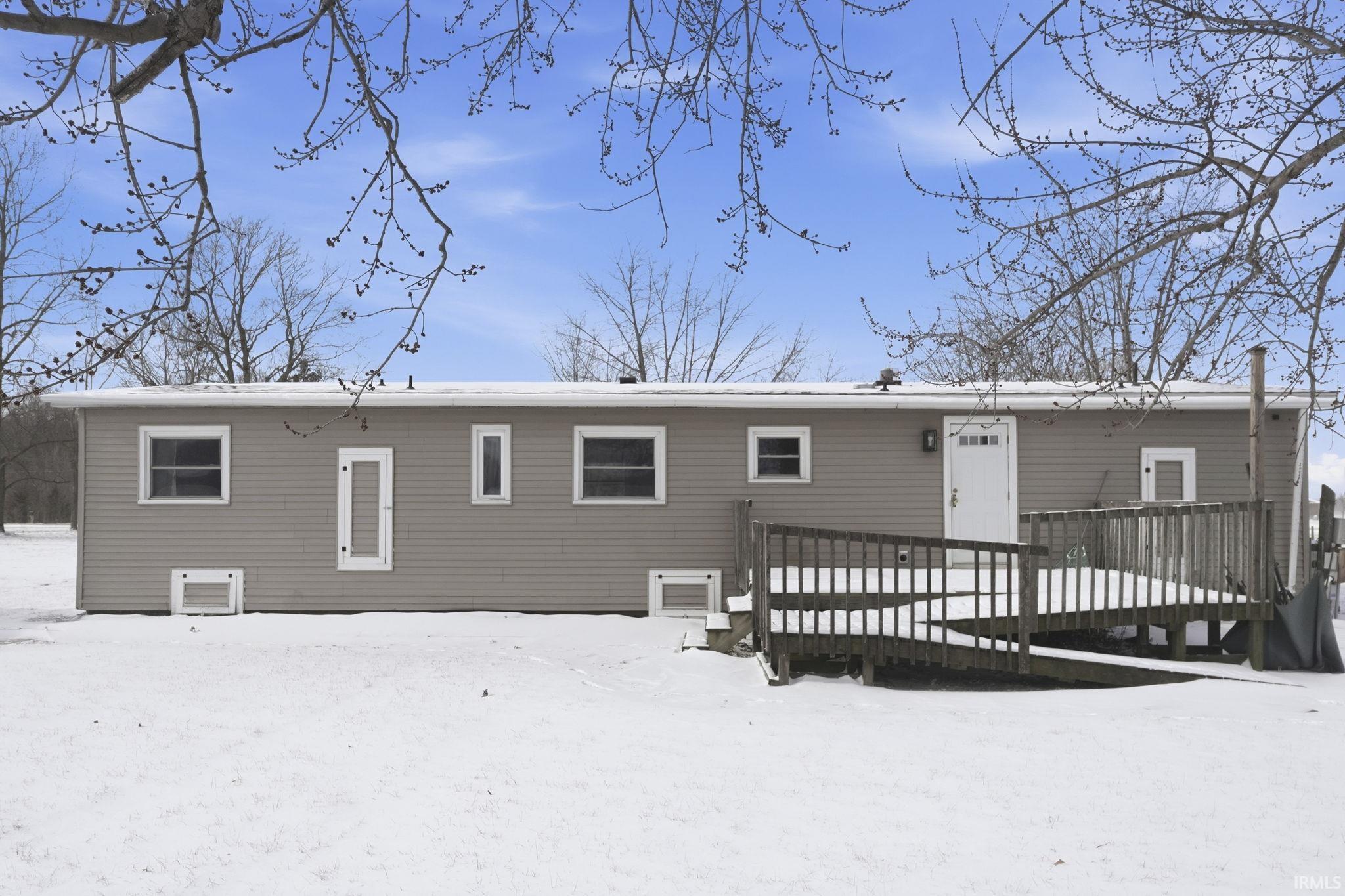 Snow covered property featuring a wooden deck
