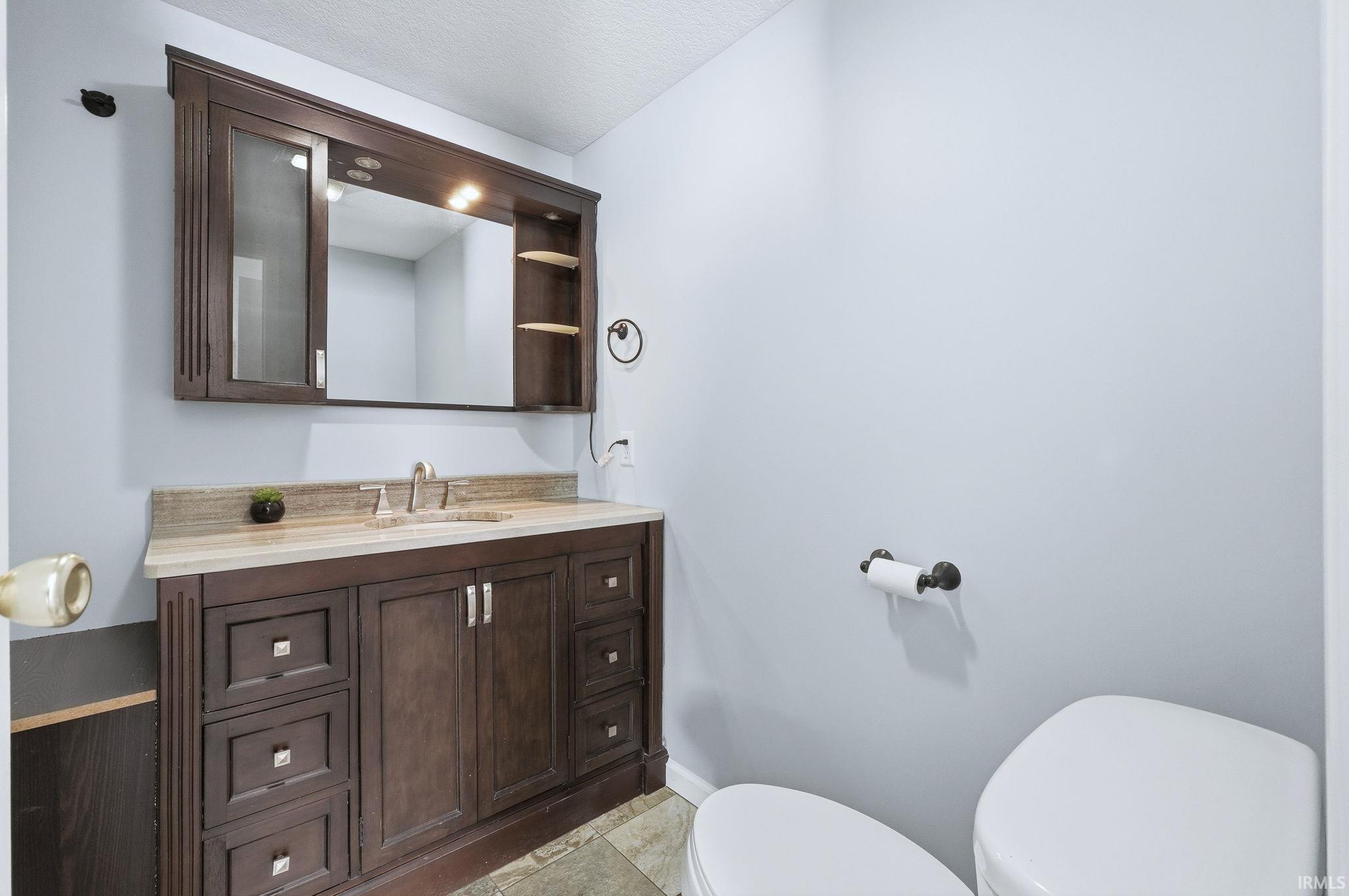 Bathroom with vanity and light tile patterned floors